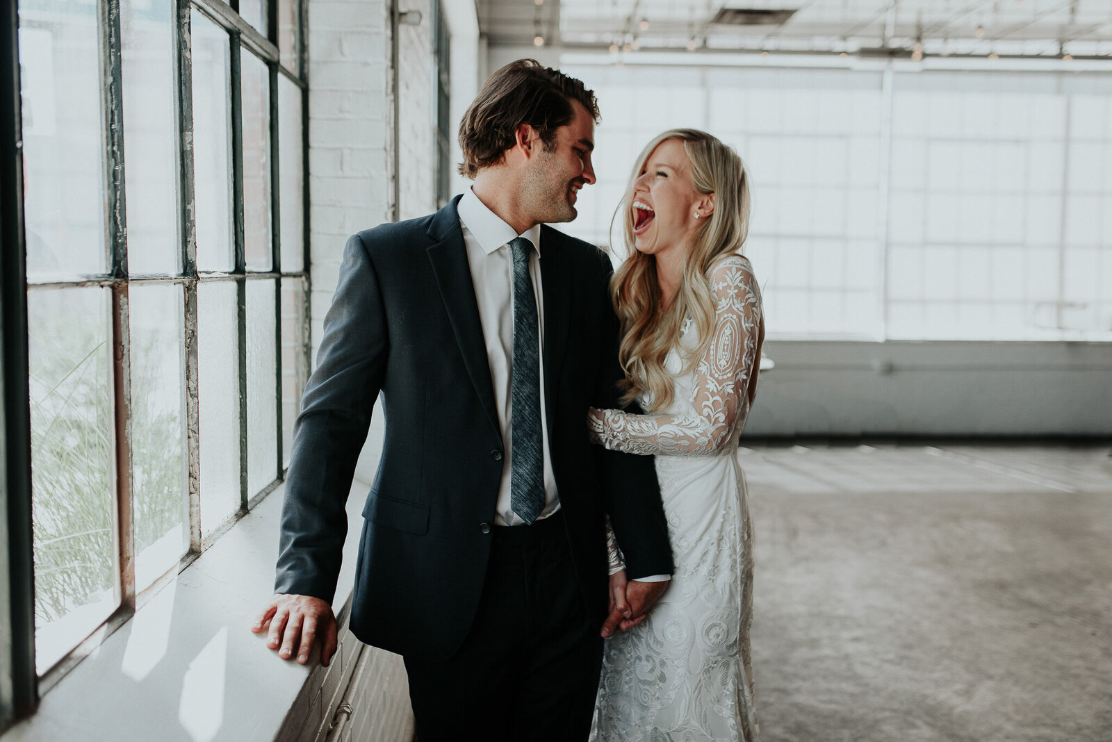 great candid photo of laughing bride with her groom urban setting in colorado