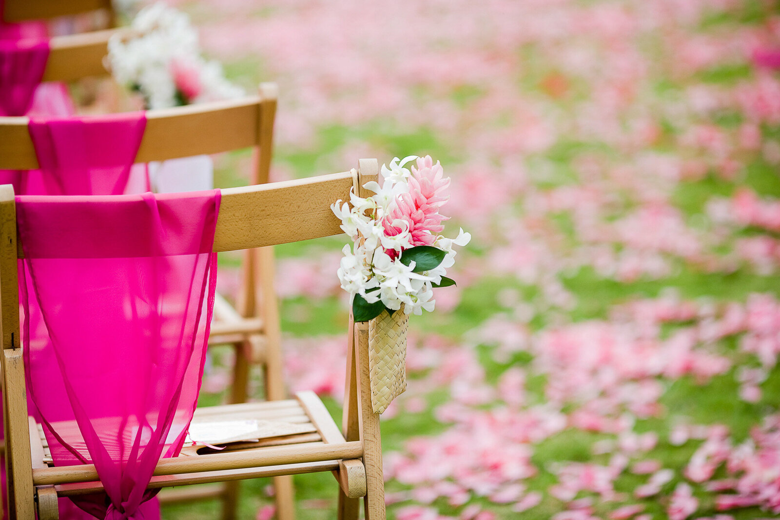 Wedding reception chair with pink details and florals