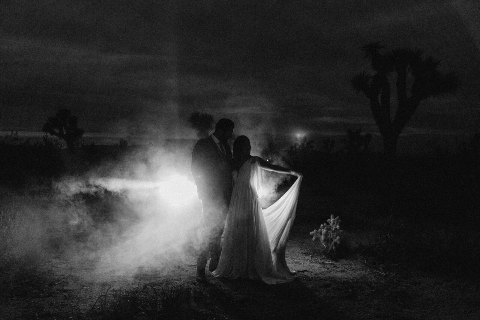 a bride and groom at night in joshua tree for their wedding