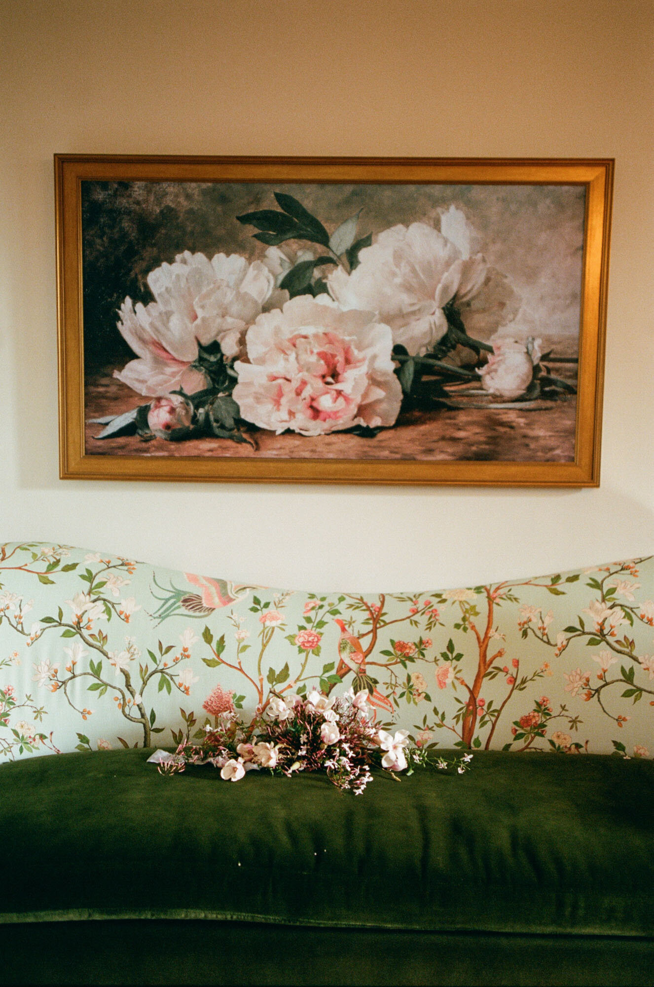 florals sitting on couch under floral painting