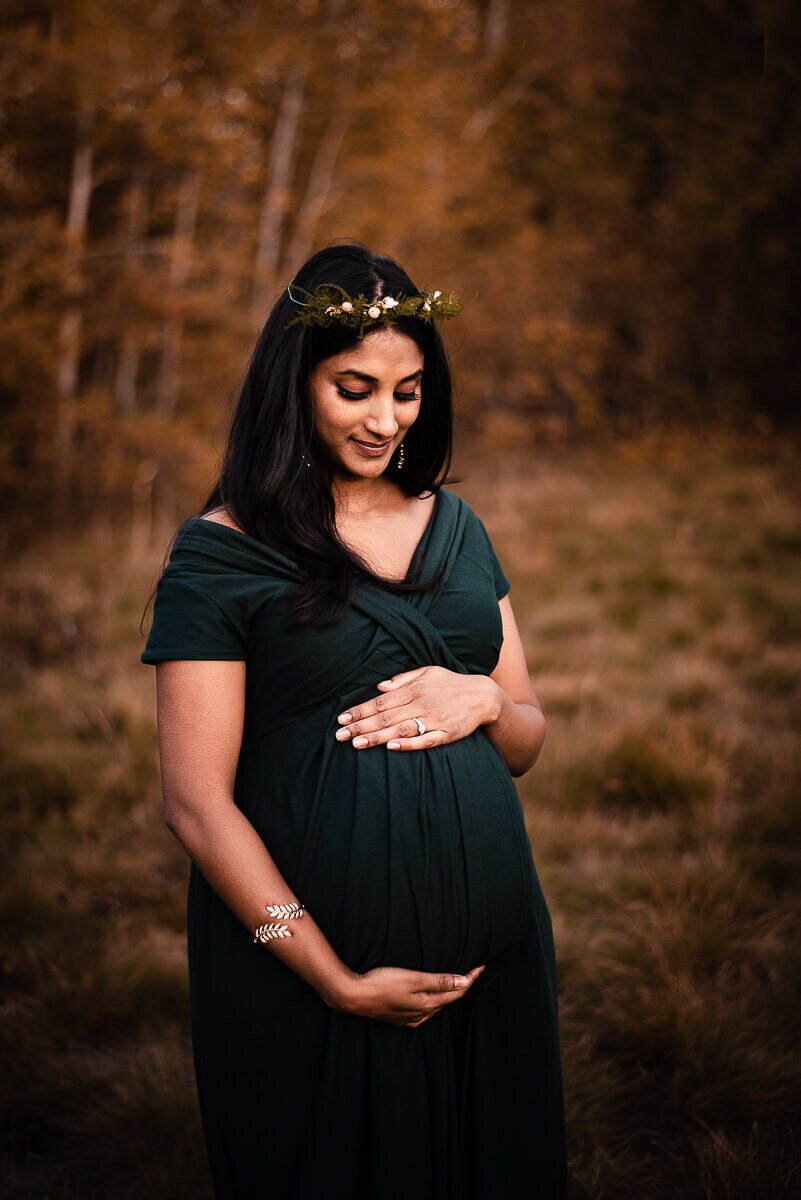 Green gown worn by pregnant mother for maternity photographer