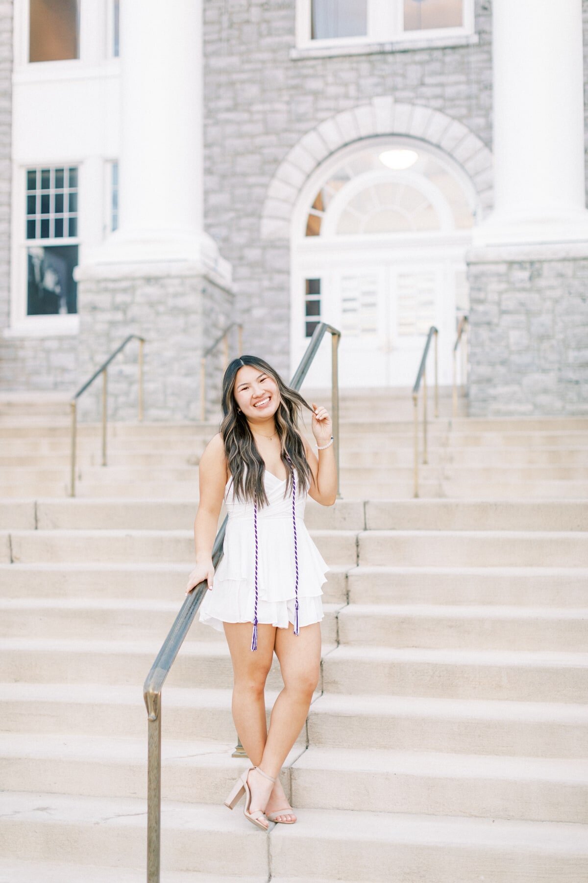A Harrisonburg senior gets her photos taken on the steps of James Madison Universities Wilson.