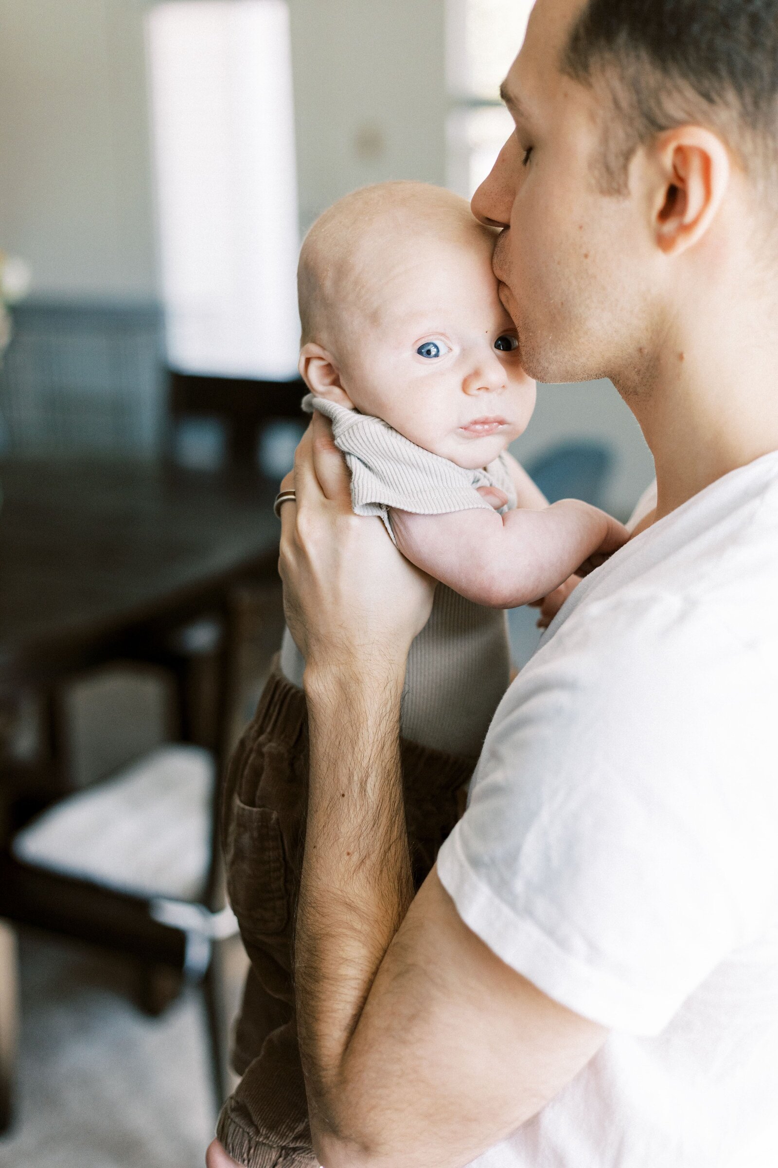 dad kissing baby during peoria illinois family photos 