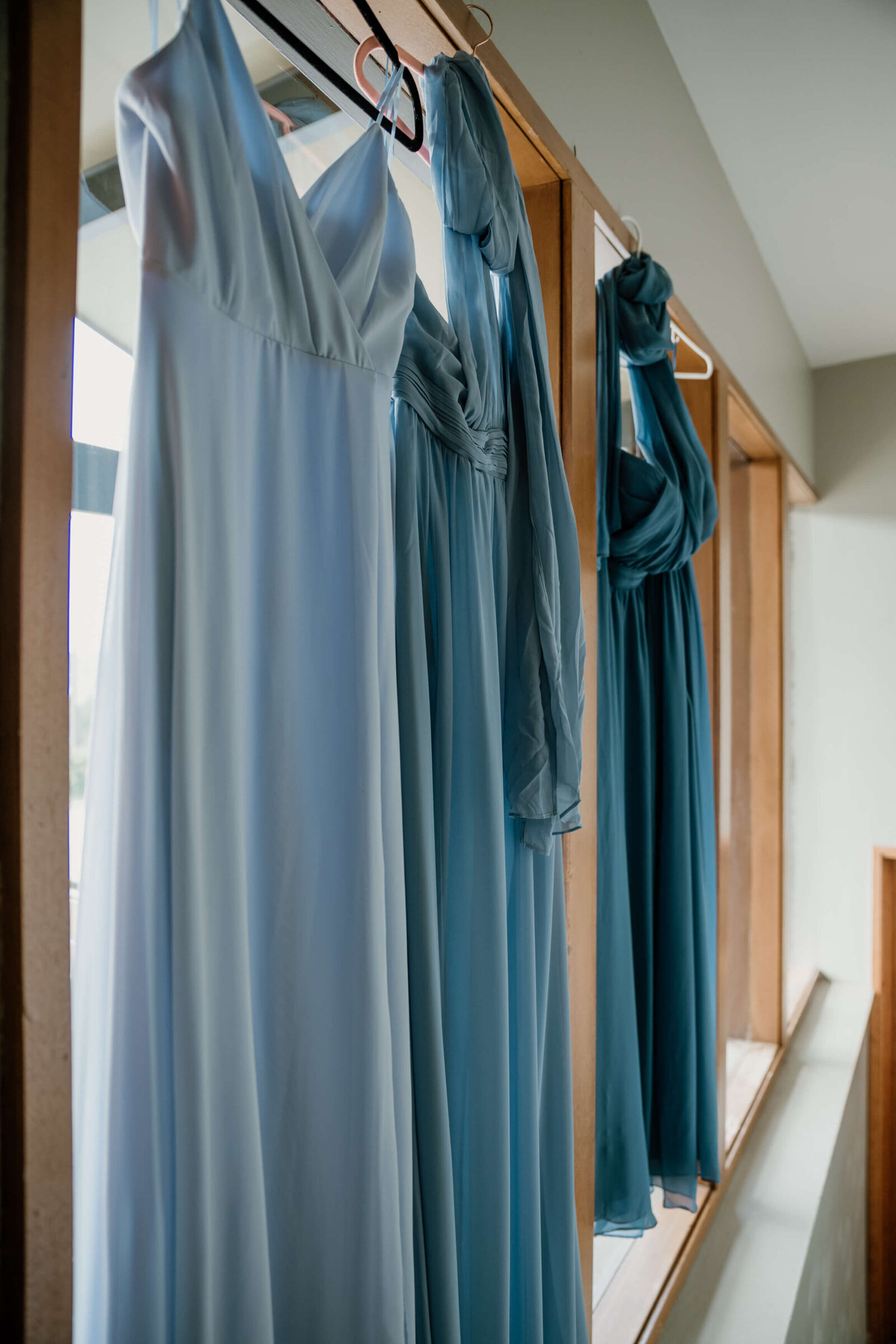 Blue Bridesmaids dresses hung up.