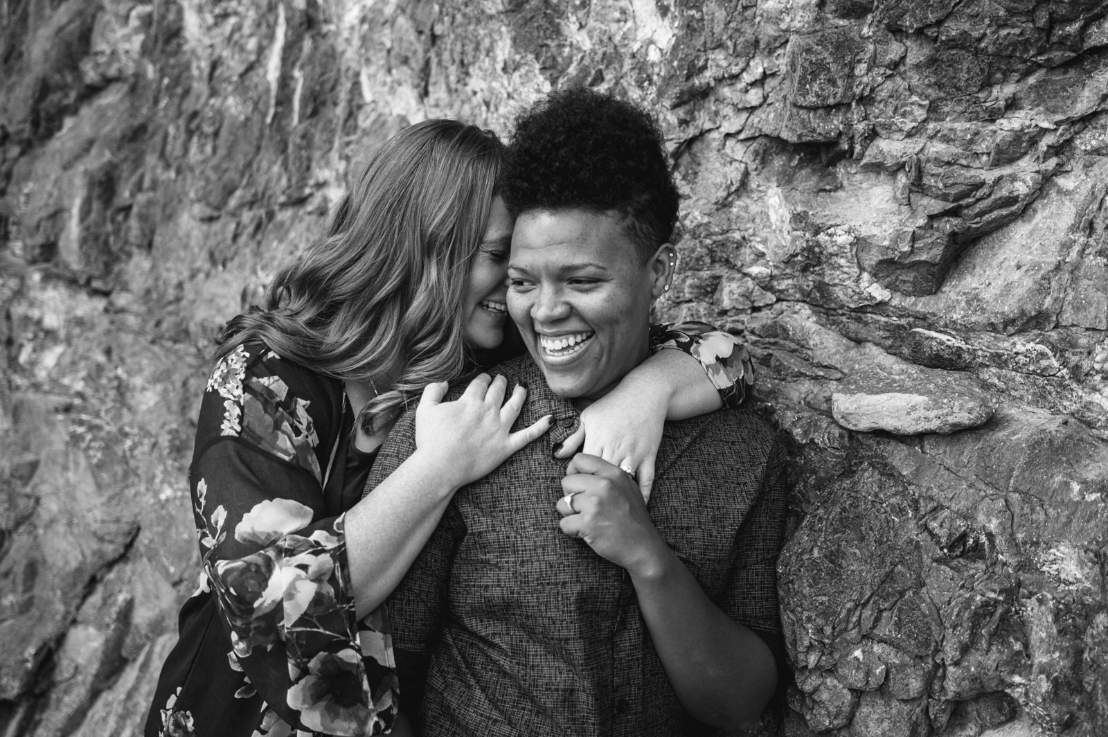 Lesbian couple laughing during engagement photos