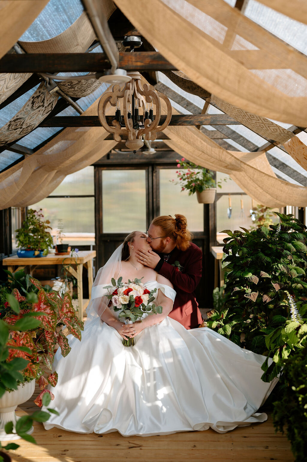 Bride and groom kissing in their wedding venue