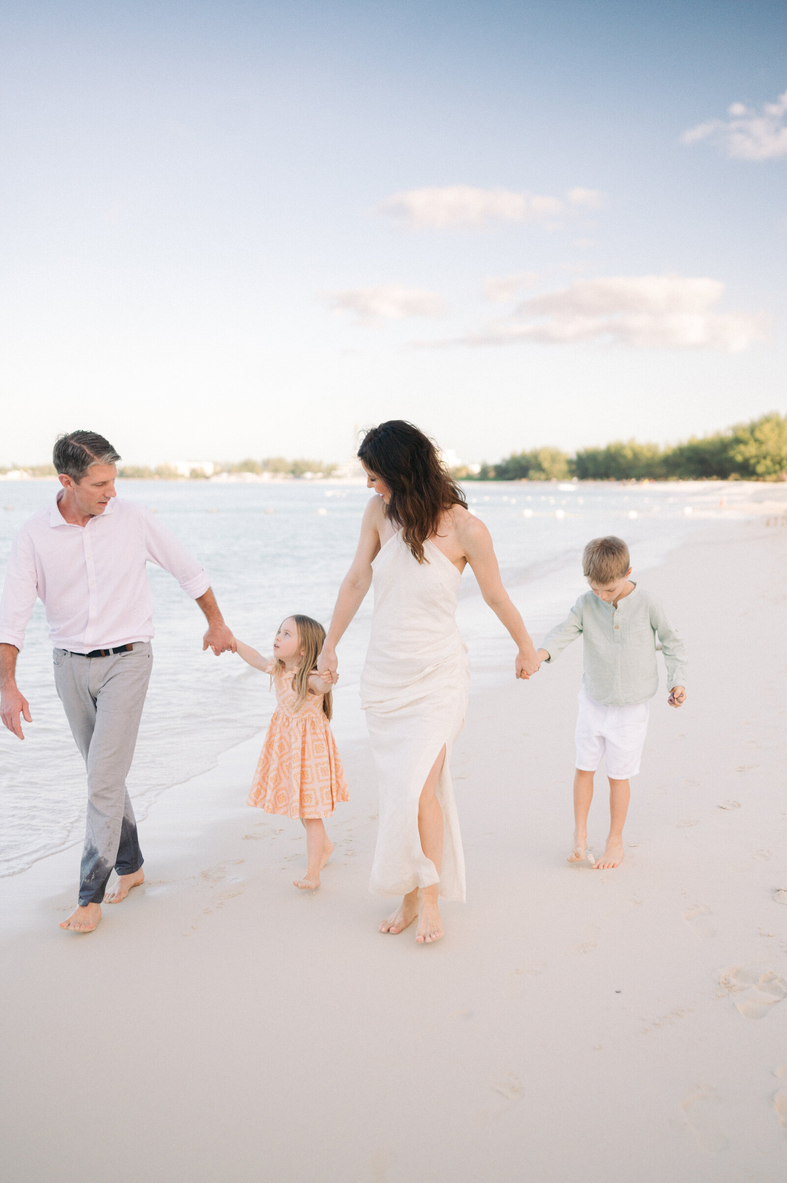 Family with small children holding hands on the beach at Grand Hyatt Baha Mar