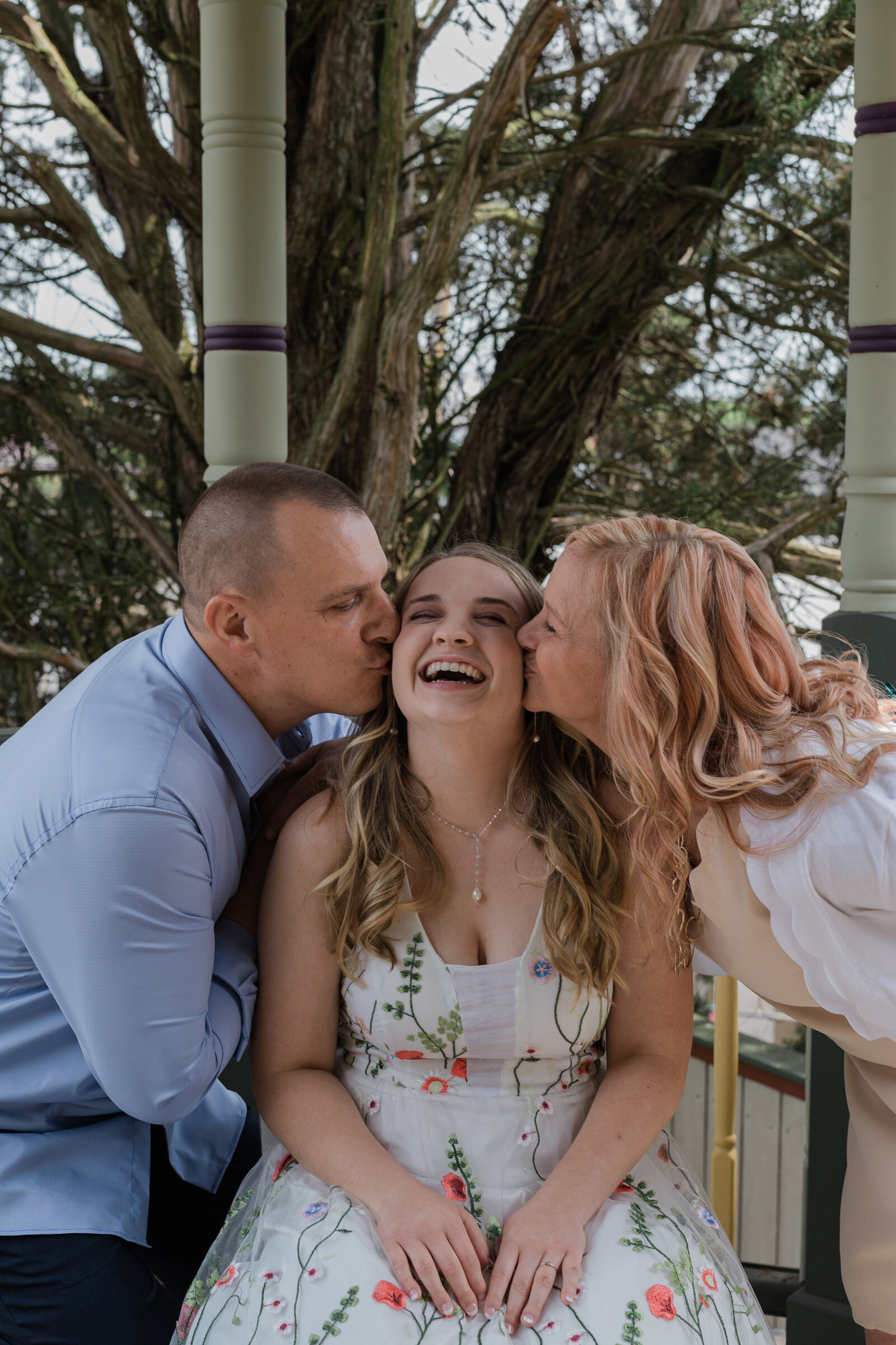 Bride is kissed by her parents