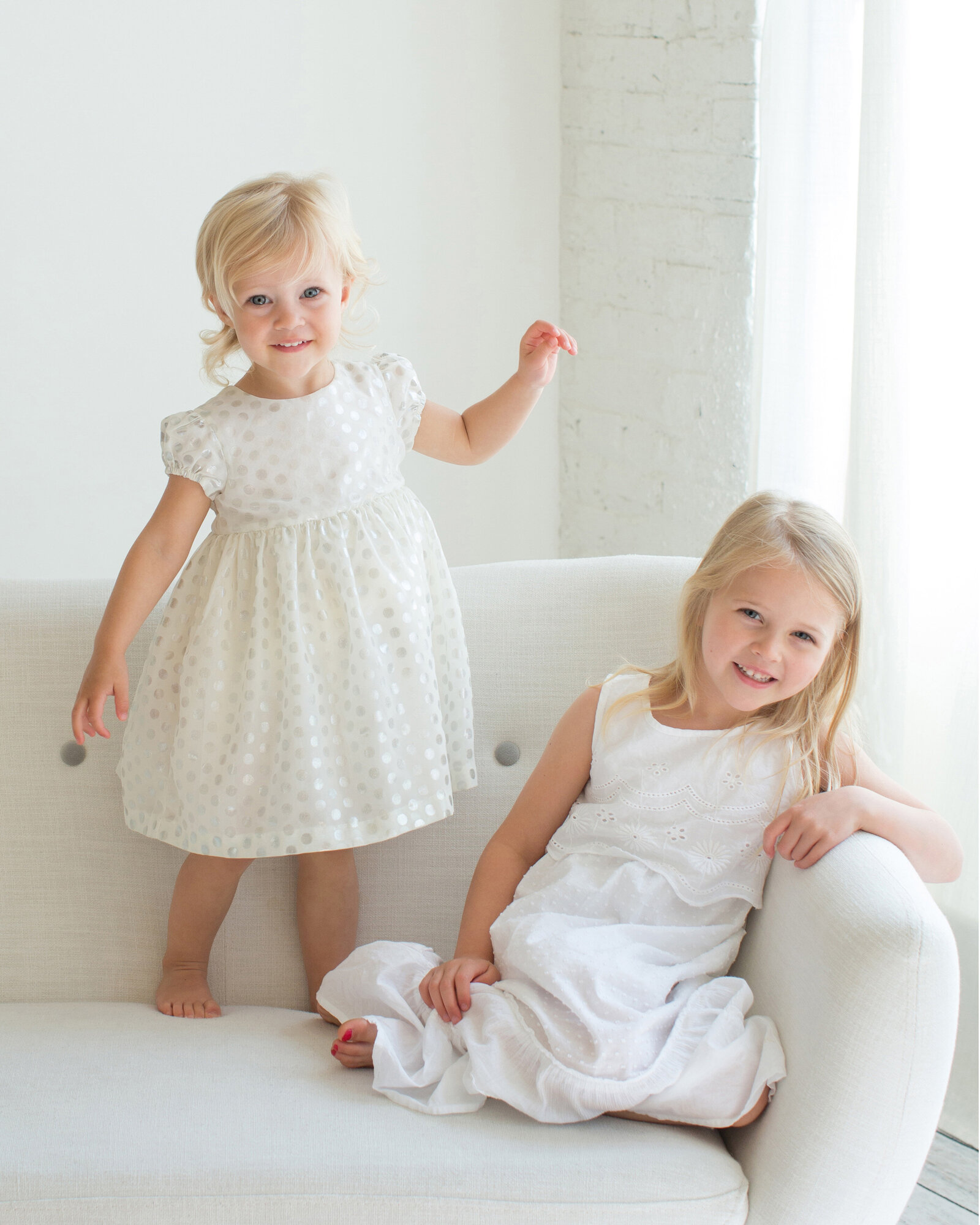 girls-smiling-in-white-dresses