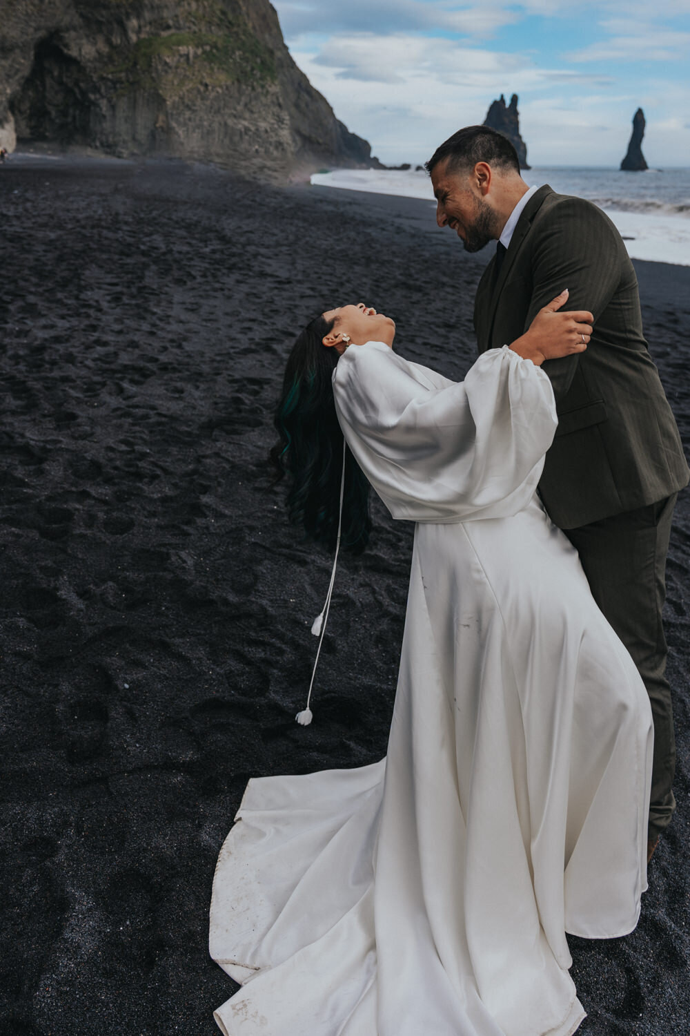 Husband dips wife during a dance on the Iceland Black Sand Beaches
