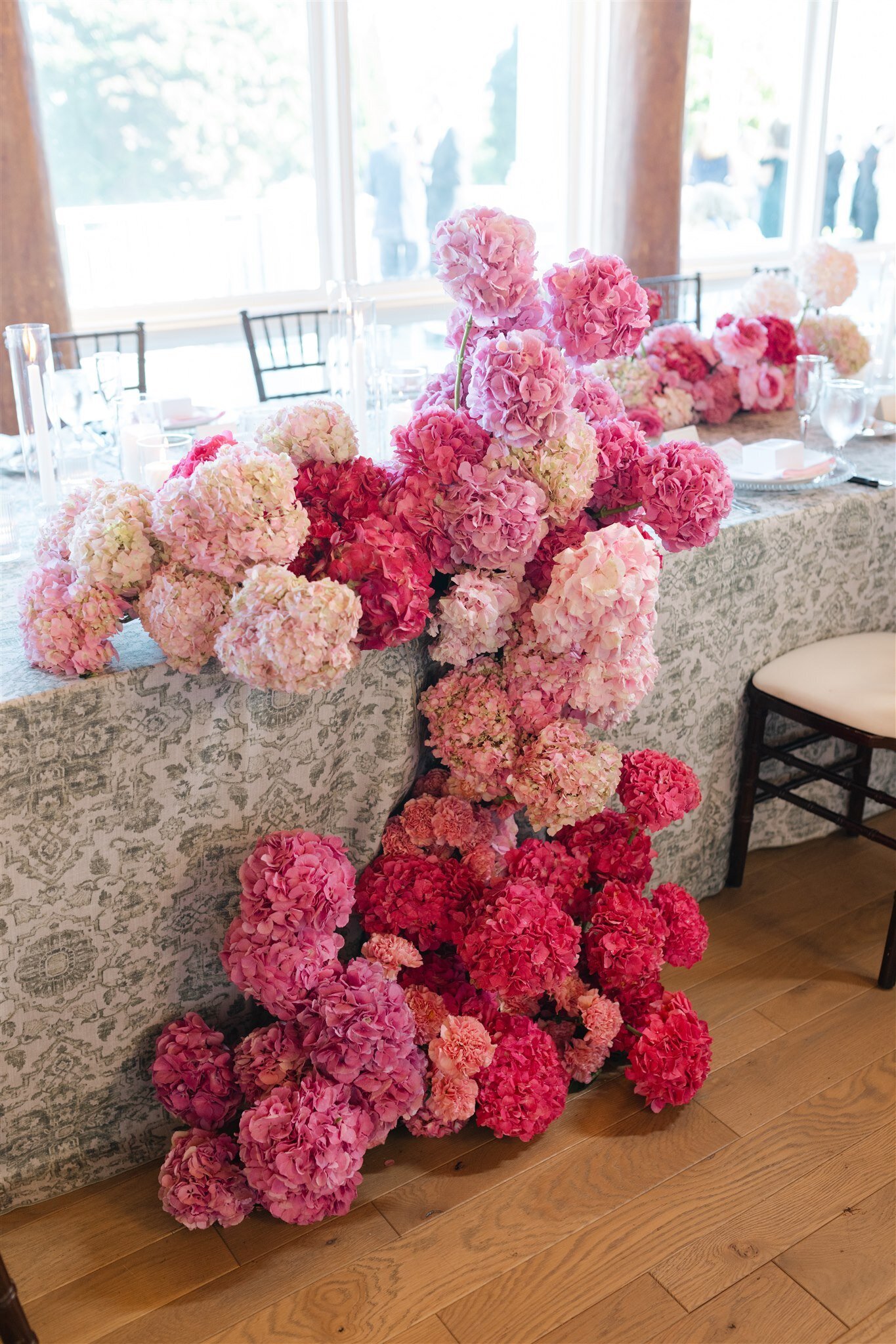A waterfall arrangement of pink hydrangeas at a wedding reception on mackinac island
