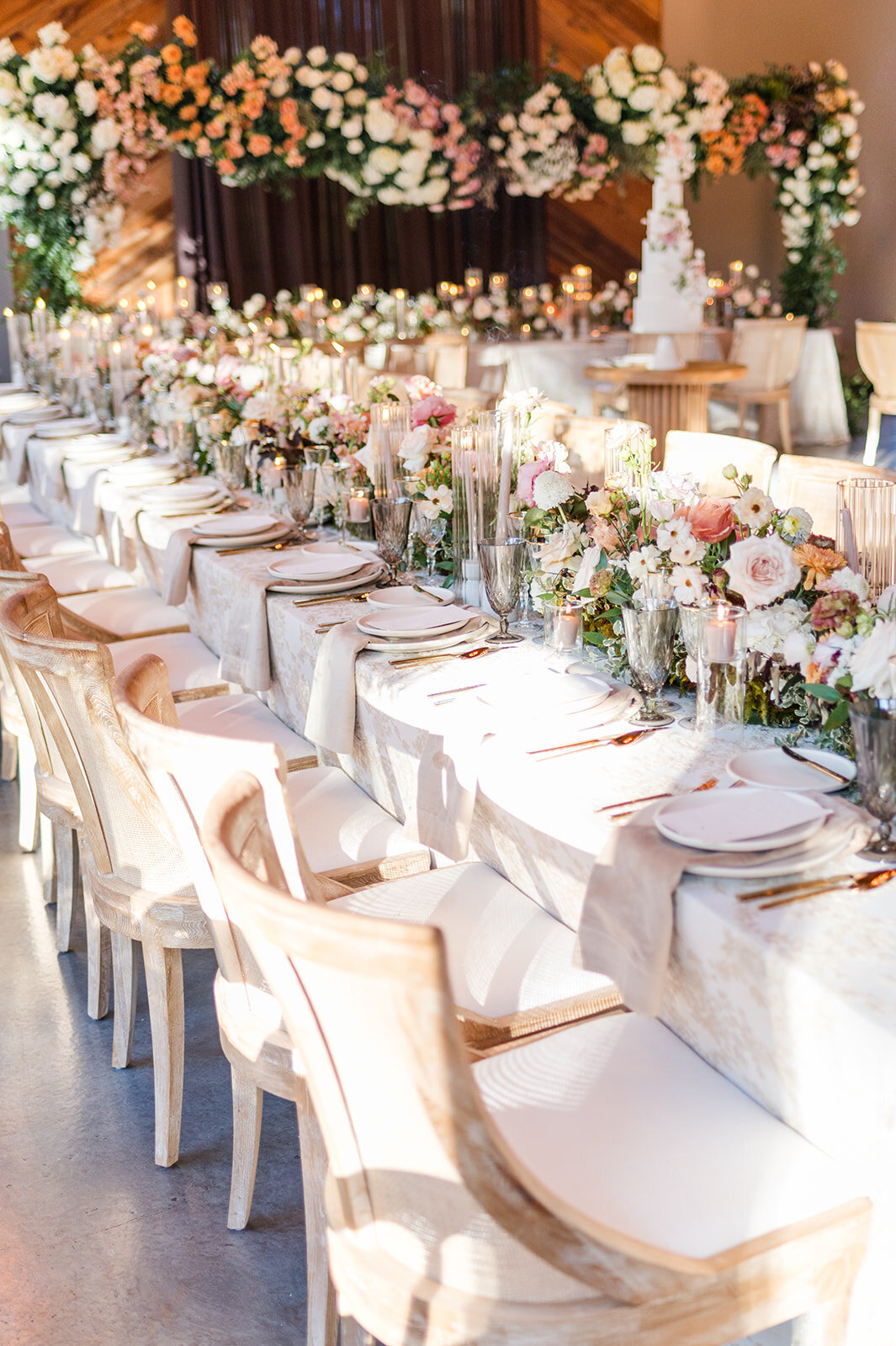 Luxury wedding flowers featuring long row of flowers down center of table
