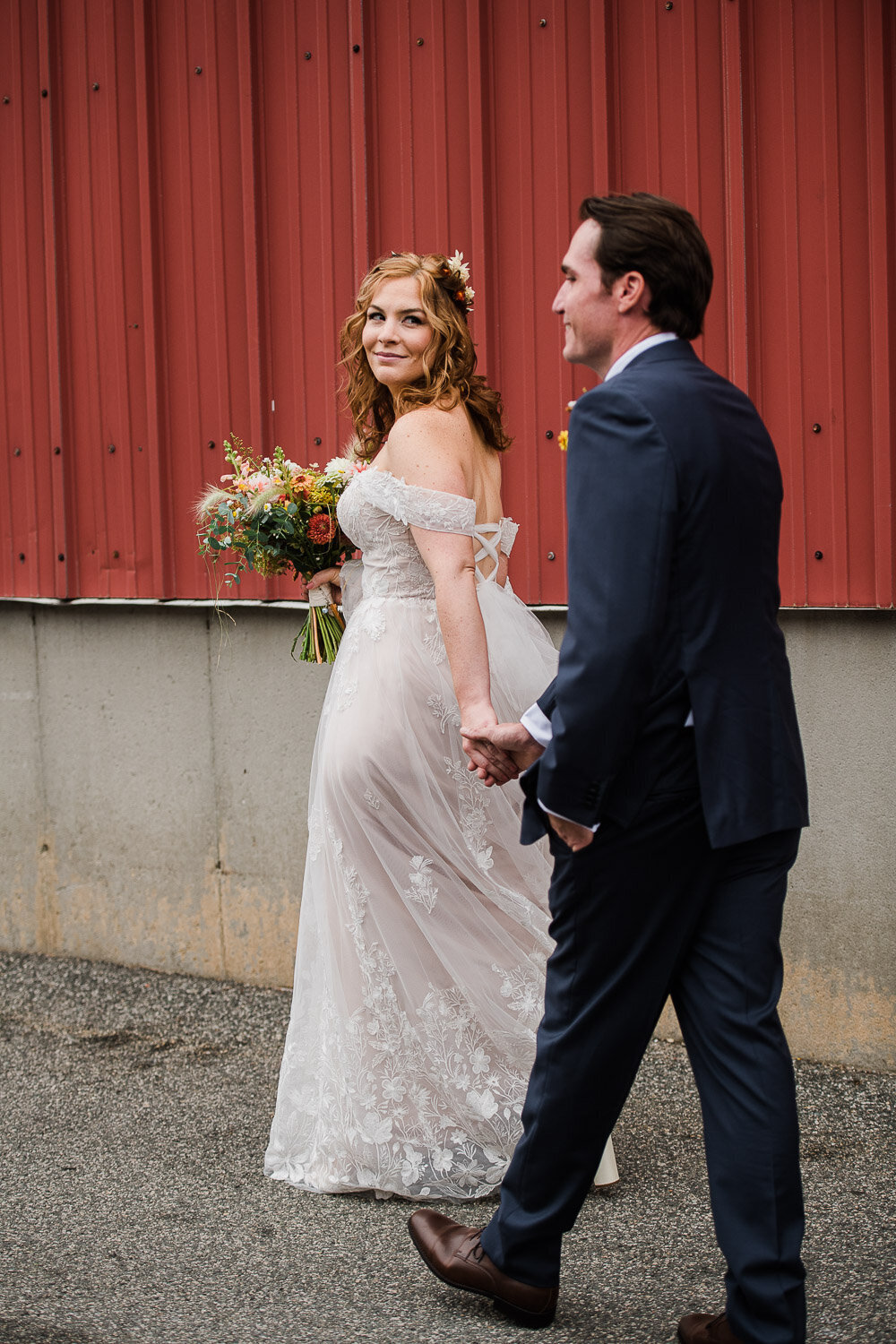 bride looking back at groom while walking