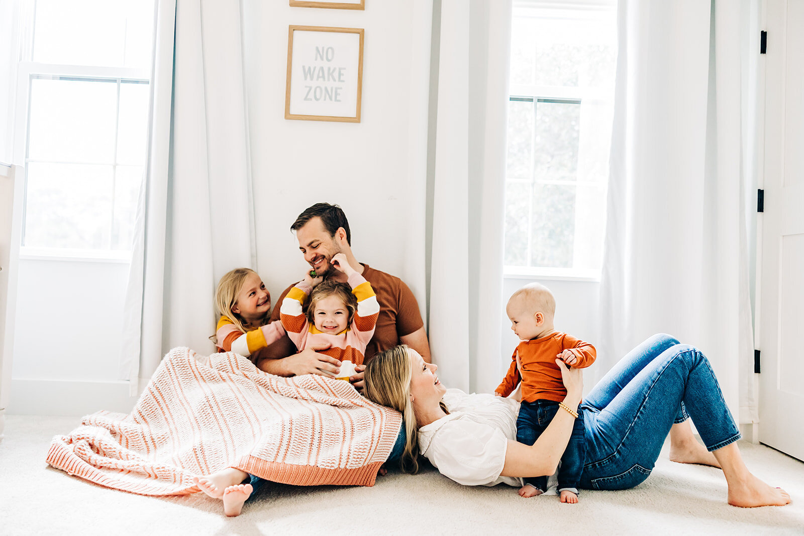 family of five cuddles in the nursery near st. Pete fl