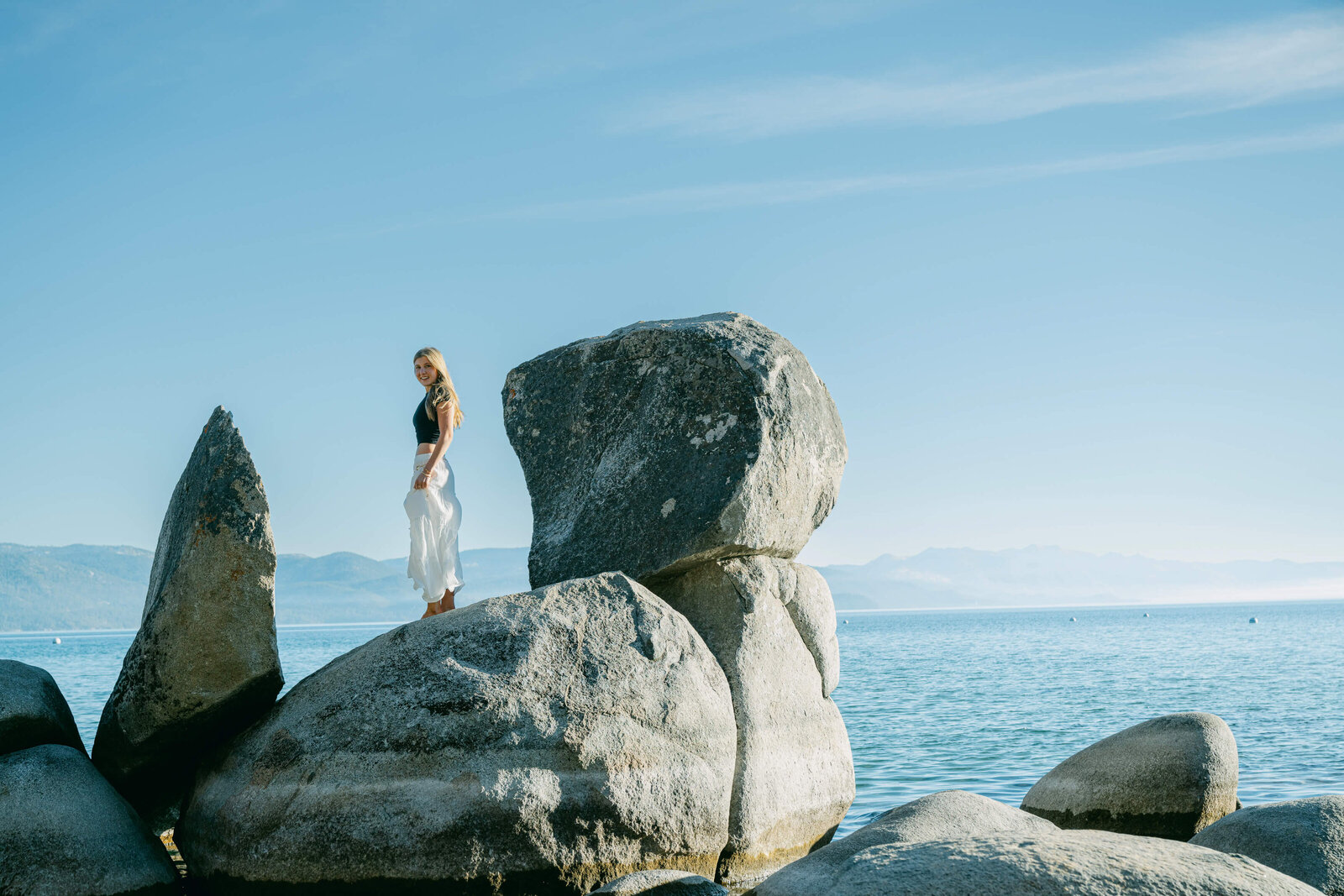 Senior high school girl on lake tahoe boulders in Lake