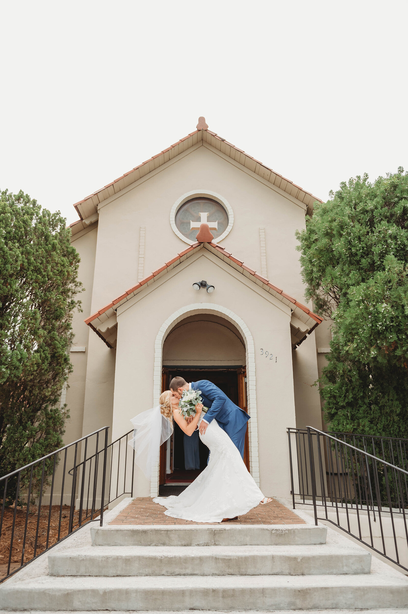 Bride and Groom kiss outside the chapel after their Micro-Wedding Ceremony in Charleston, SC.