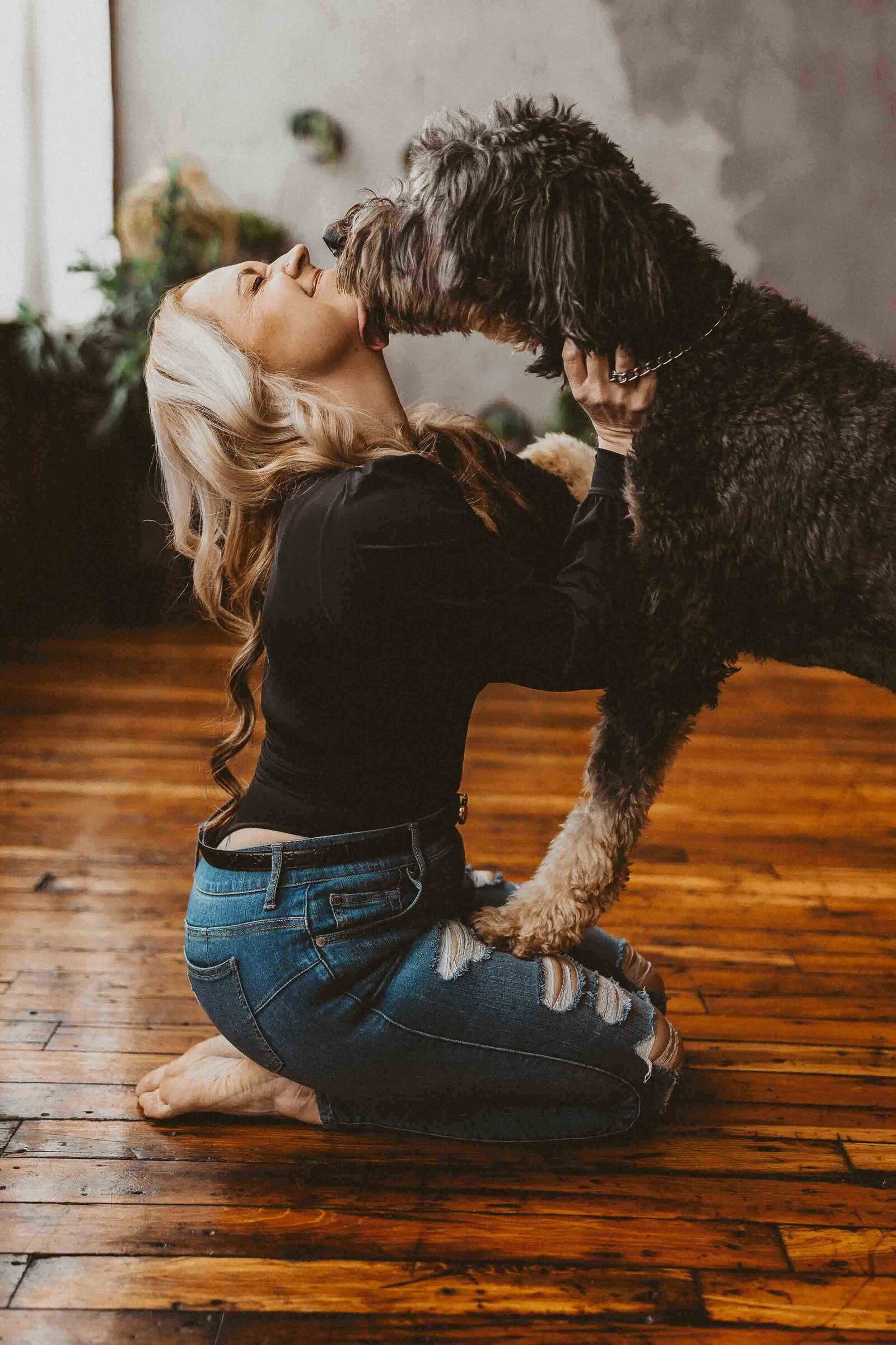 woman kissing her pet dog