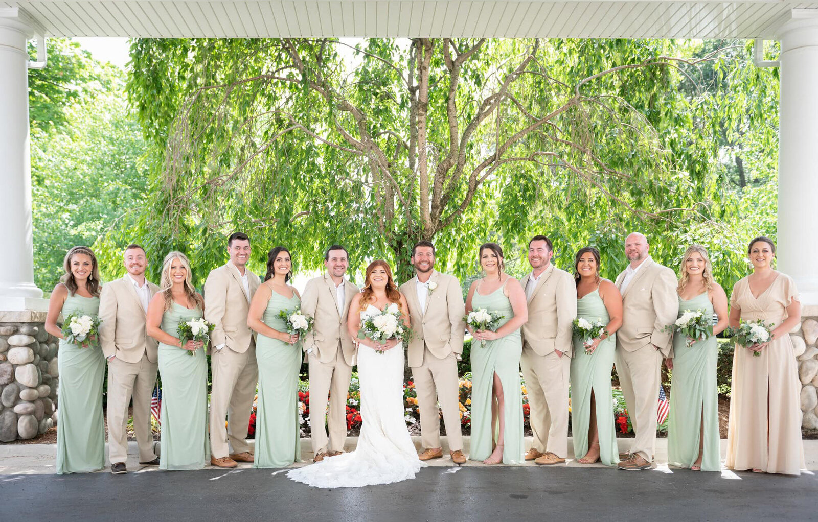 bride hold grooms arm and close their eyes
