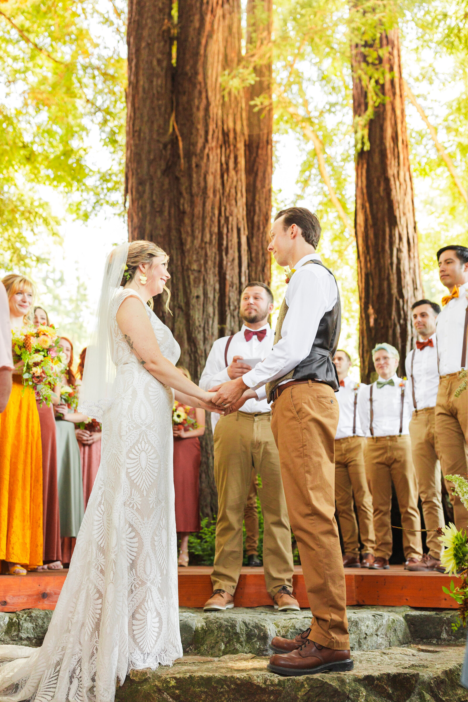 Bride and groom at their colorful wedding ceremony in Santa Cruz, California in the redwood trees.
