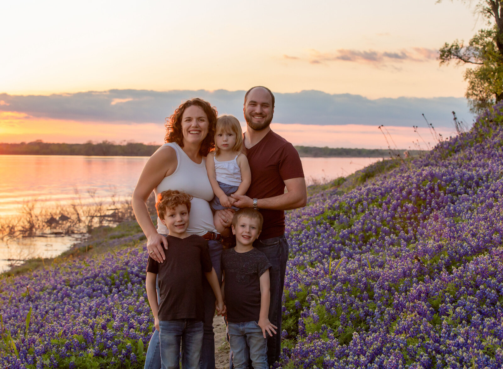 texasn family in bluebonnets at sunset