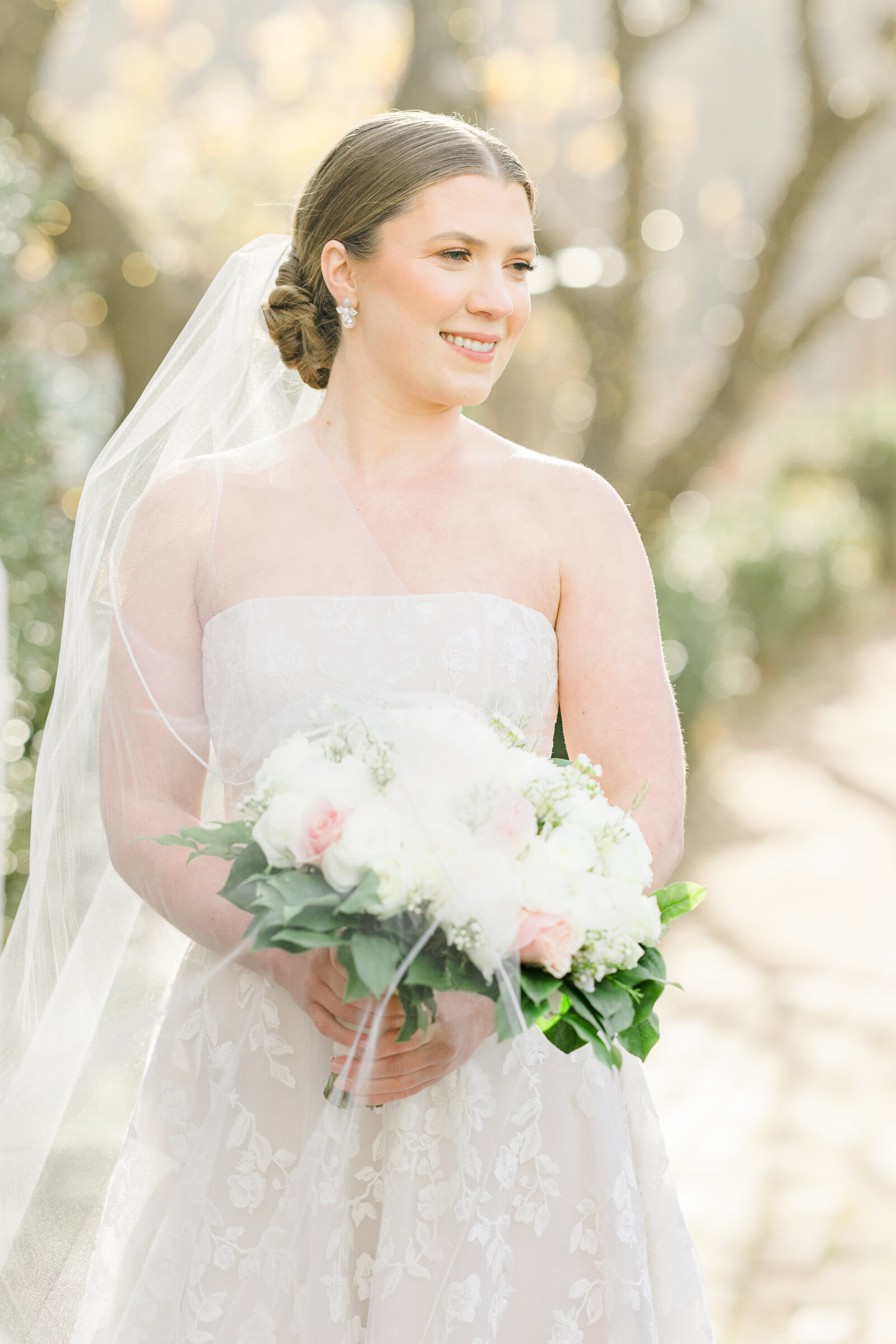 Bride poses gracefully at Inola, her wedding gown flowing as she smiles, radiating joy and anticipation for the unforgettable day ahead.