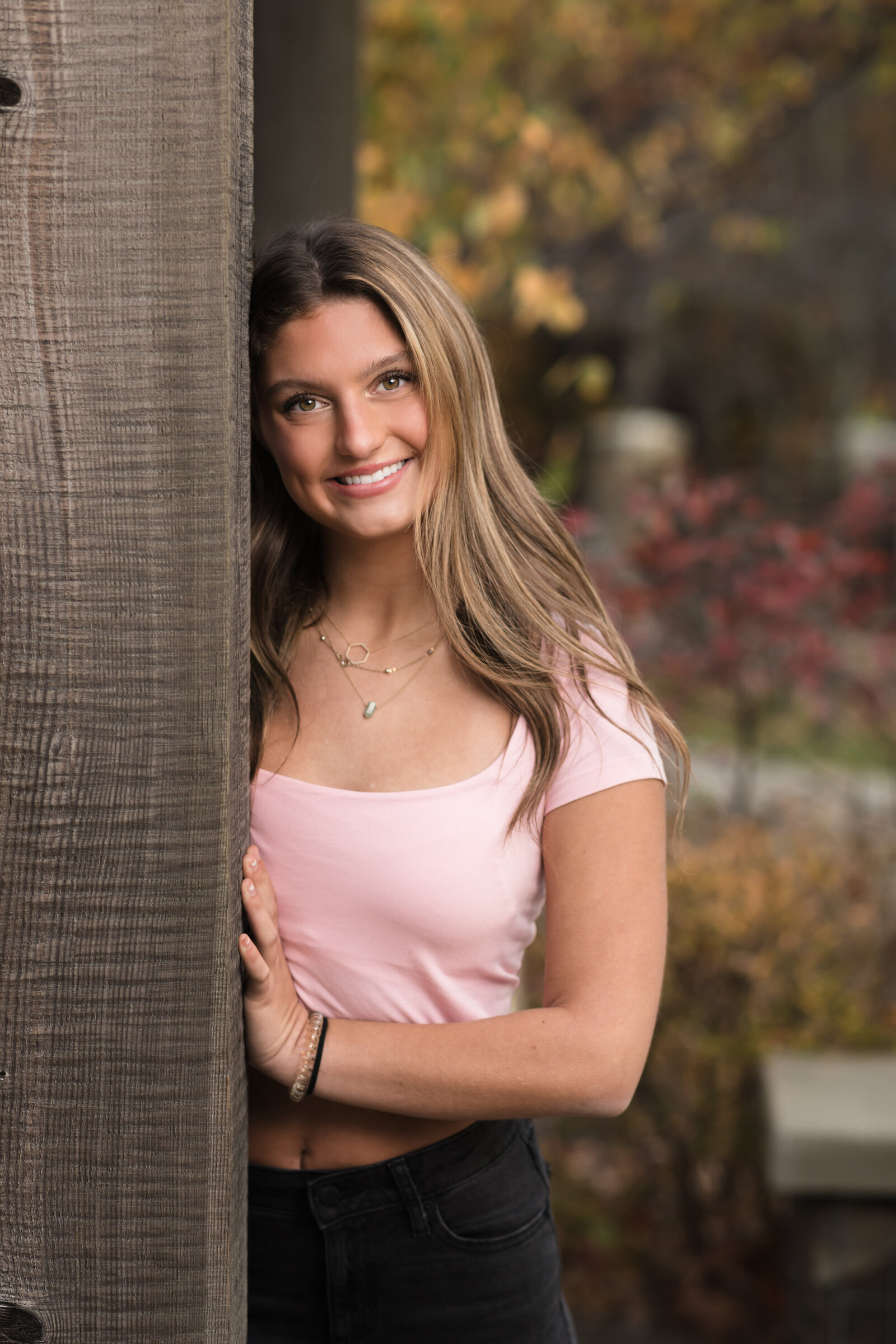 high school senior girl in pink shirt posing for senior portraits cleveland senior photographer