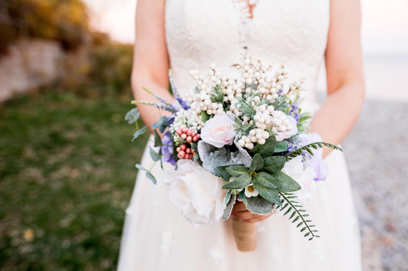 Closeup of Bride's dress and bouquet.
