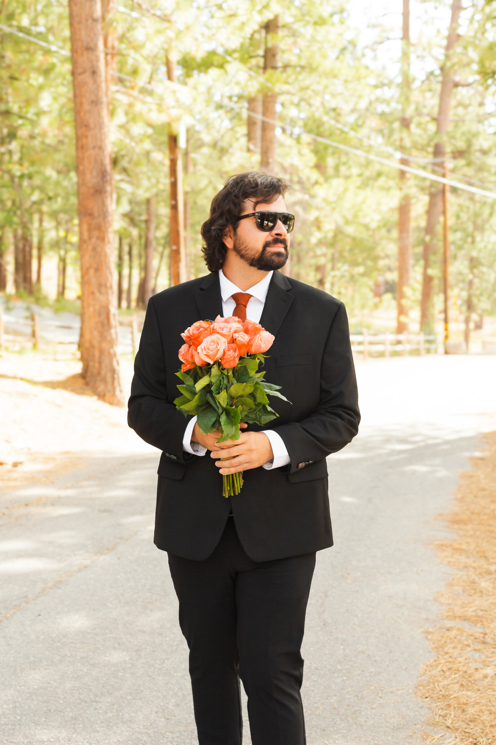 A groom celebrates his intimate elopement at a cabin at Big Bear Lake, California.