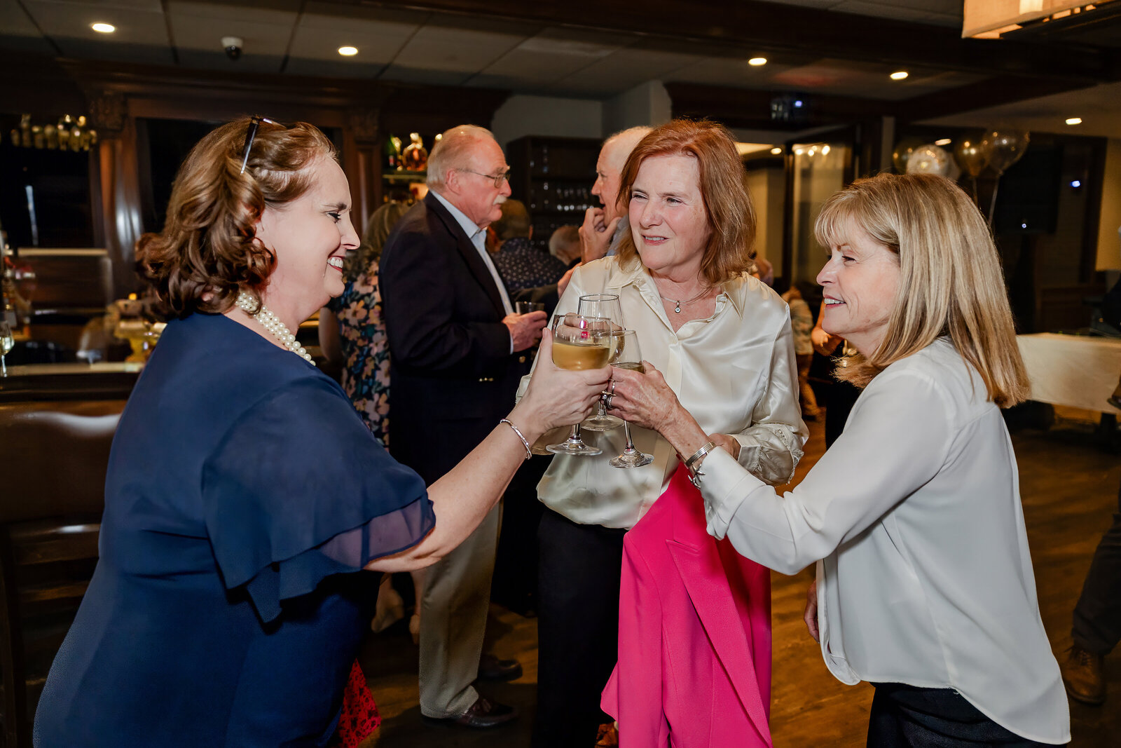 Guests clinking wine glasses in a toast