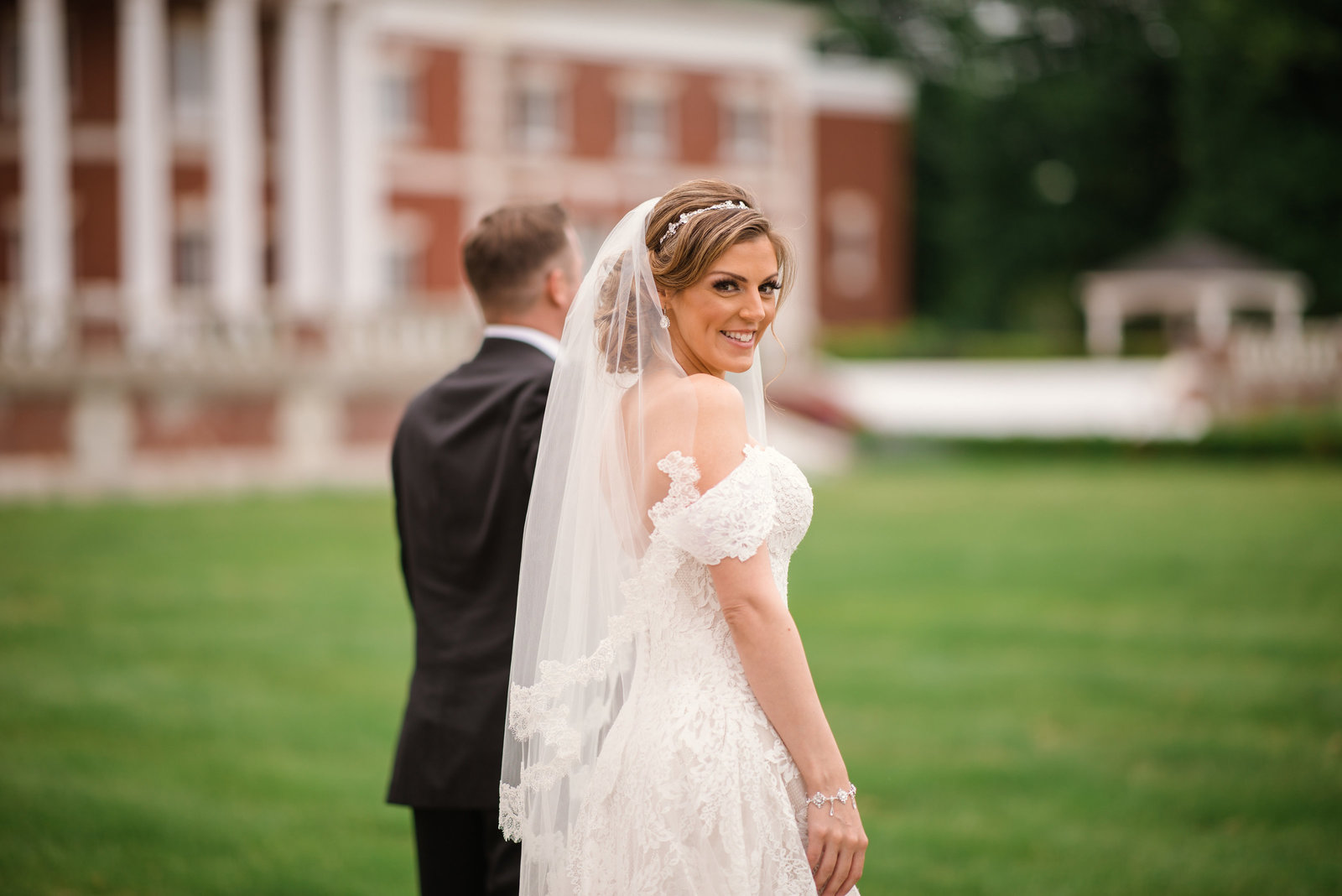 Bride and groom walking on the grounds of the Bourne Mansion
