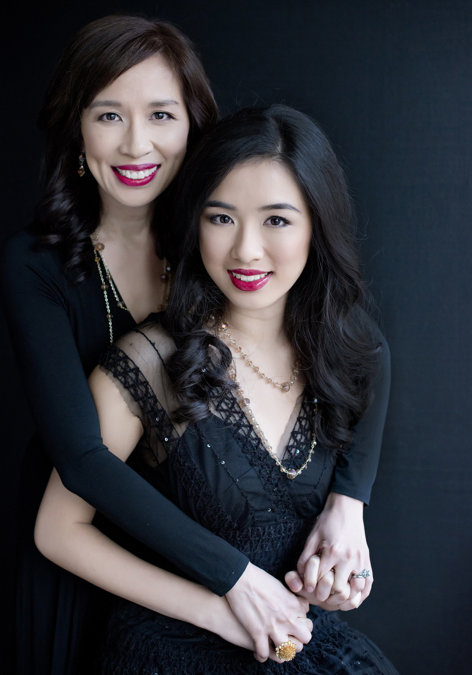 Portrait  of  Toronto asian  Realtormother and  daughter with beautiful smile  holding hands and sharing their  beautiful relationship