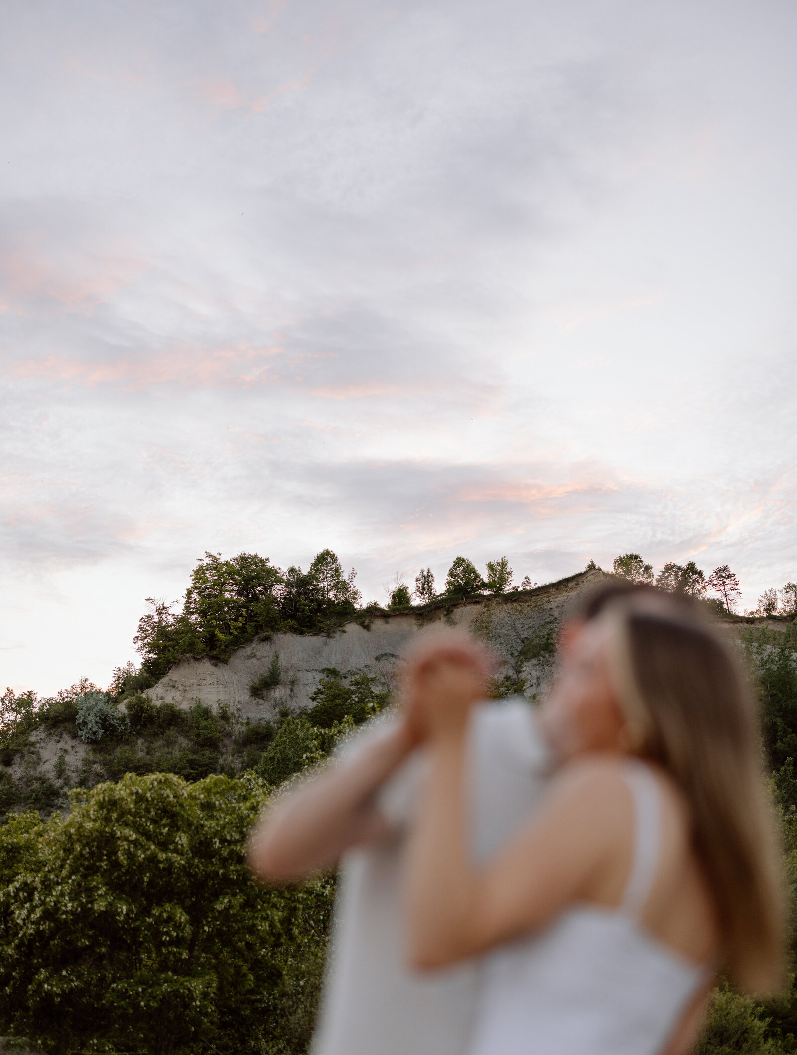 A couple dancing during sunset on the beach at Scarboro bluffs.