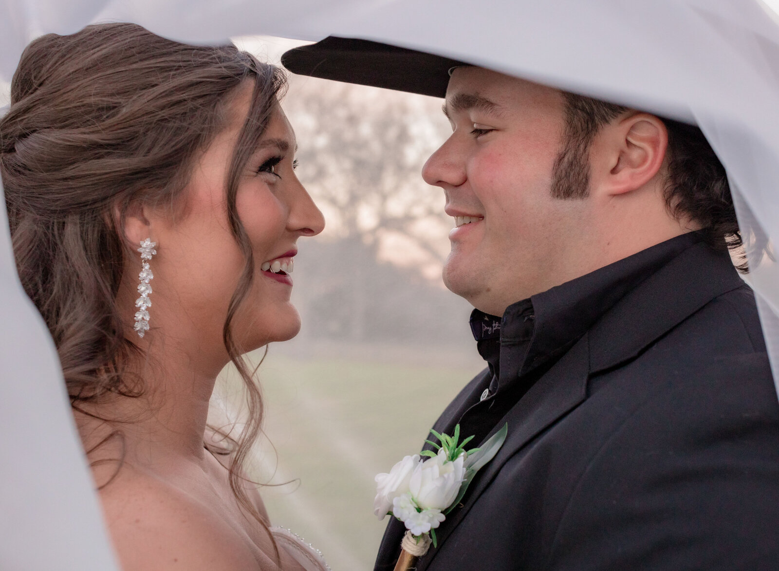 happy couple under veil