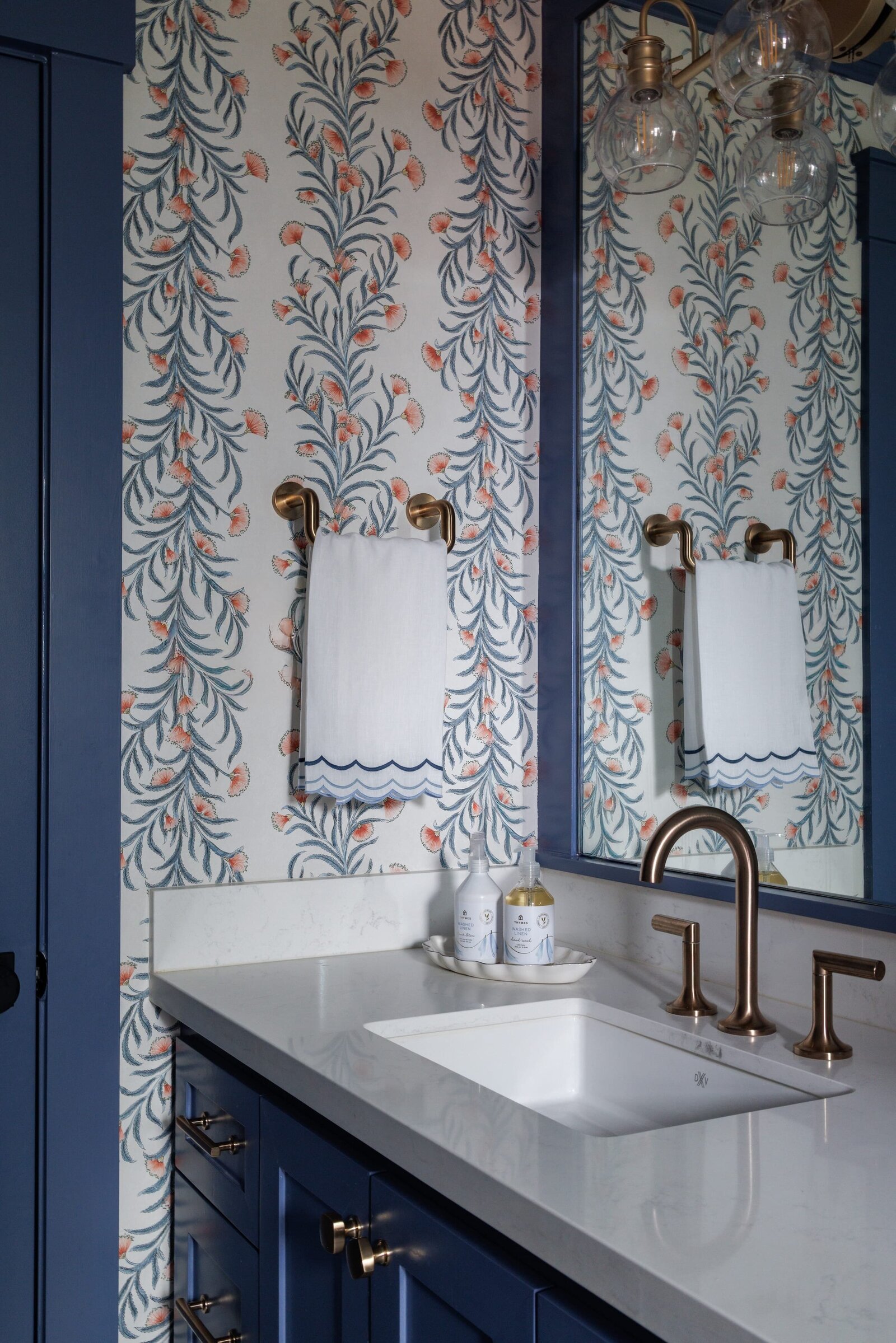vision and hammer interior design bathroom with bold wallpaper and dark blue painted cabinets