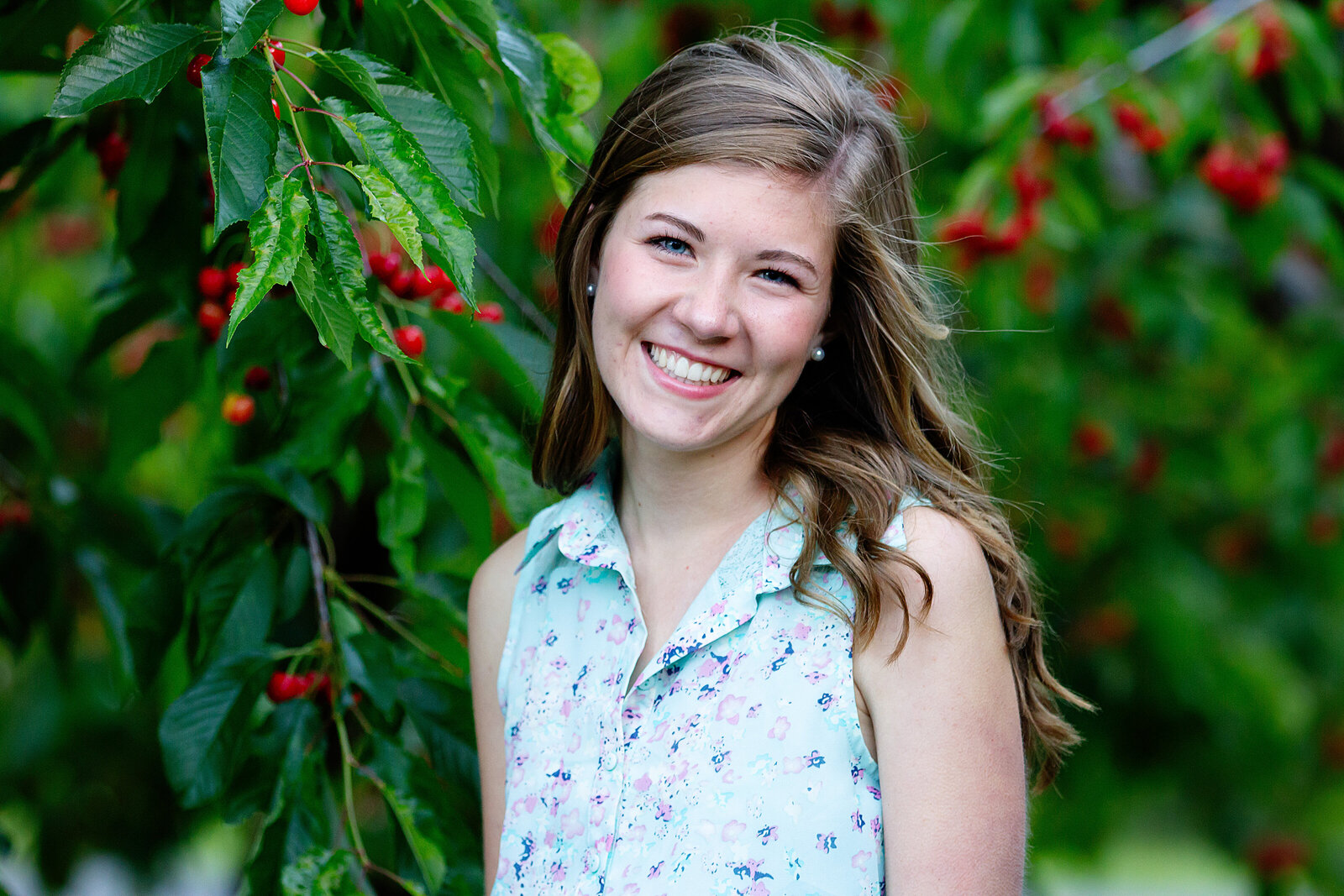 Senior photos in a cherry tree orchard