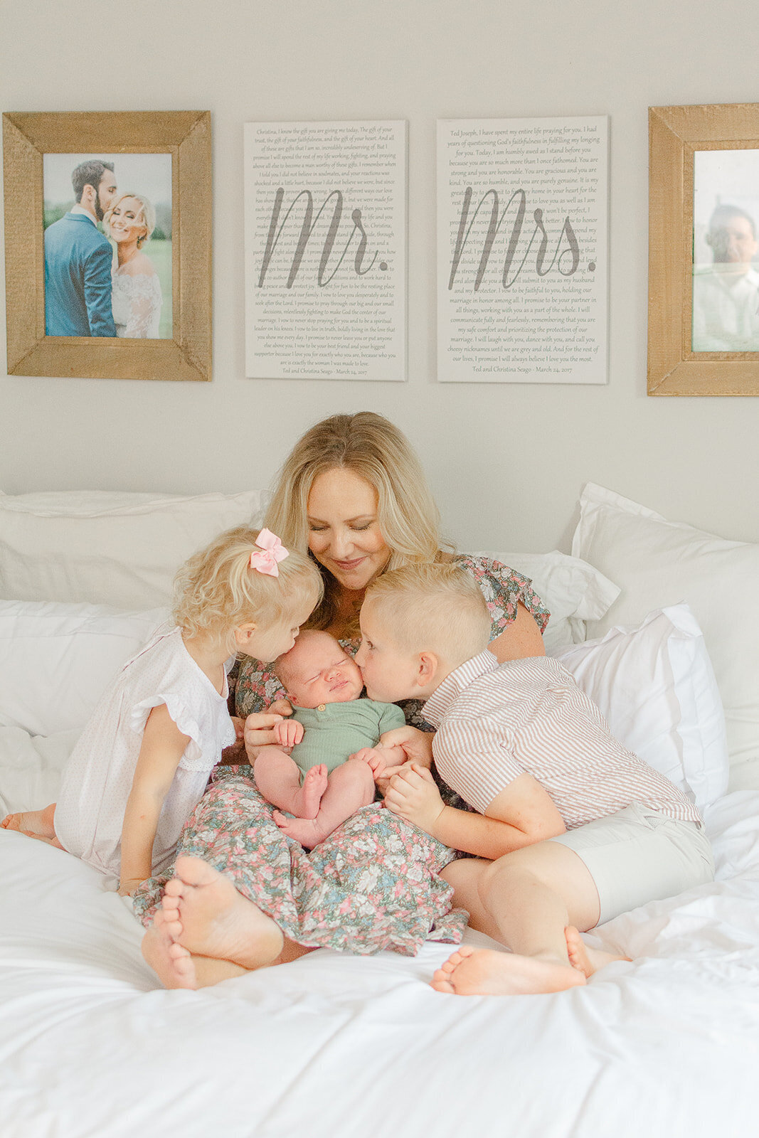 older siblings kiss baby DMV during newborn photo