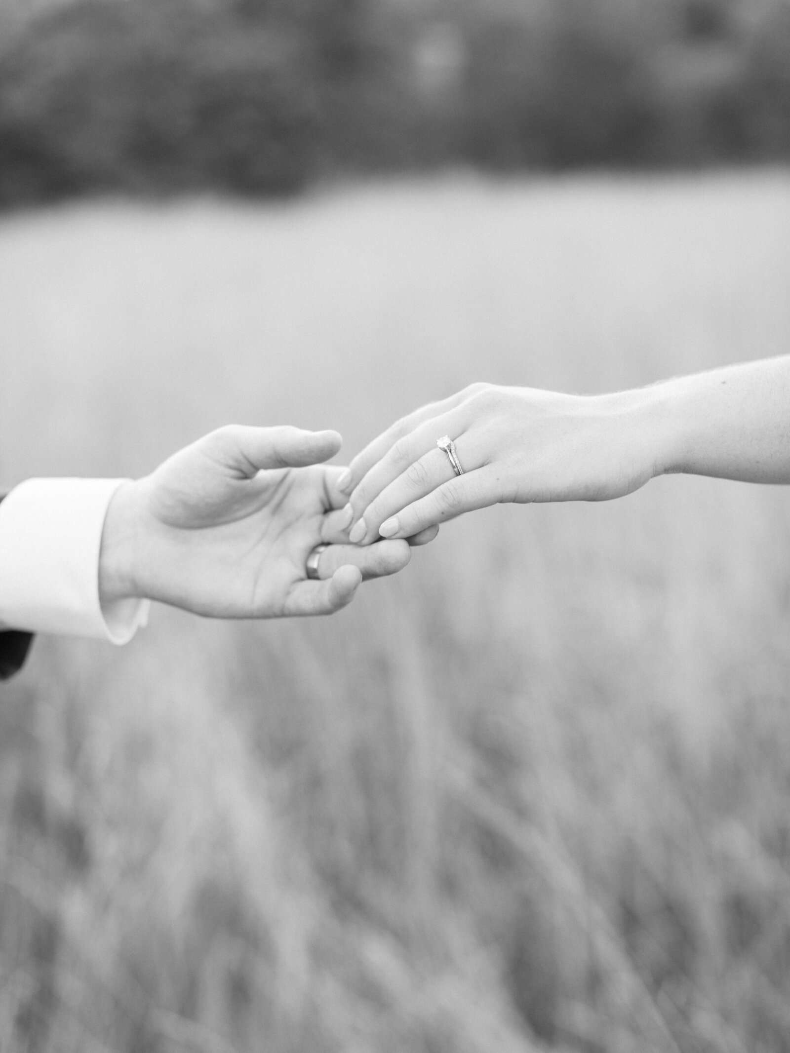 Editorial picture of a bride and grooms hands