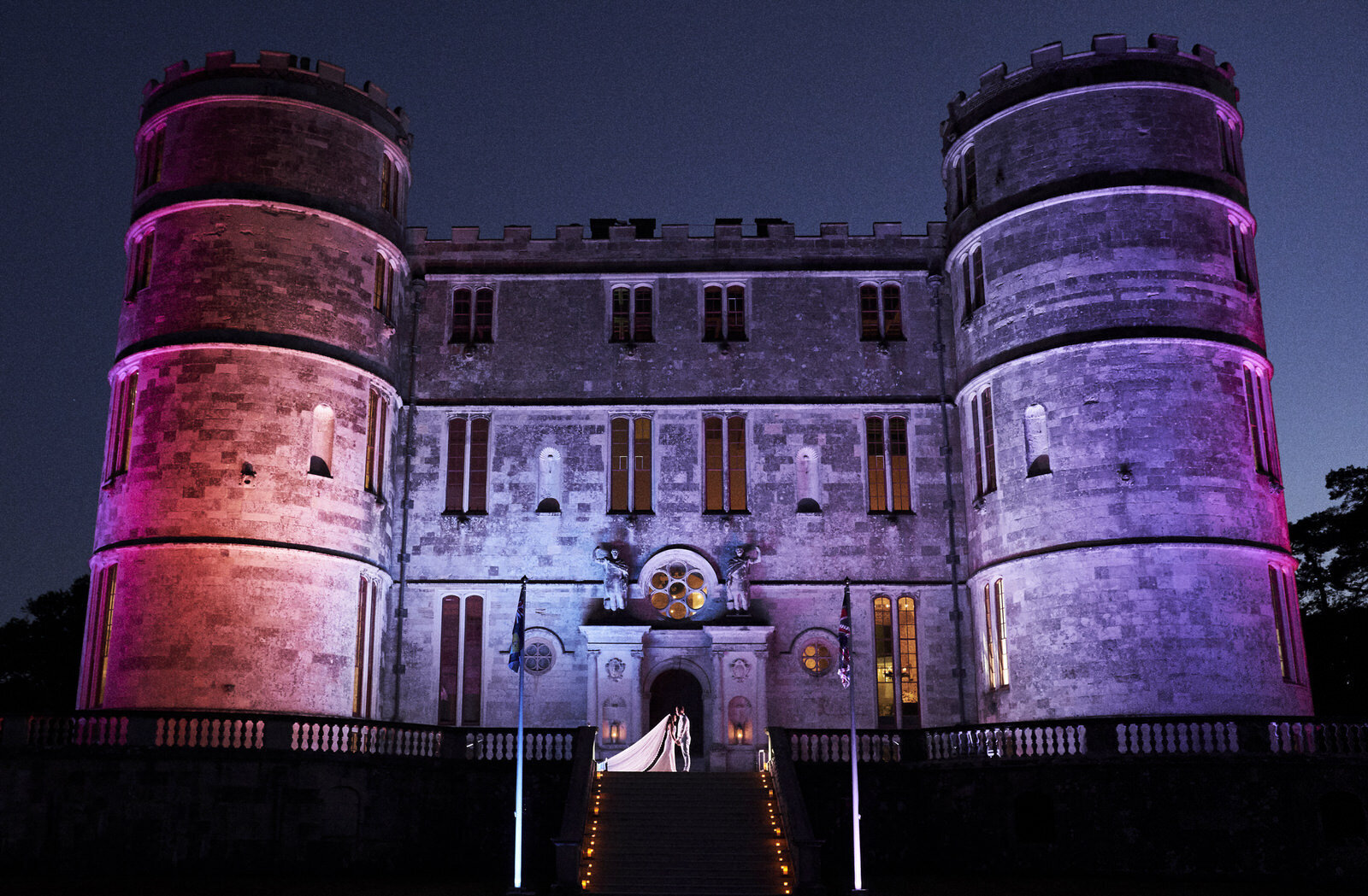 Castle light up with colored lights at night for wedding reception party