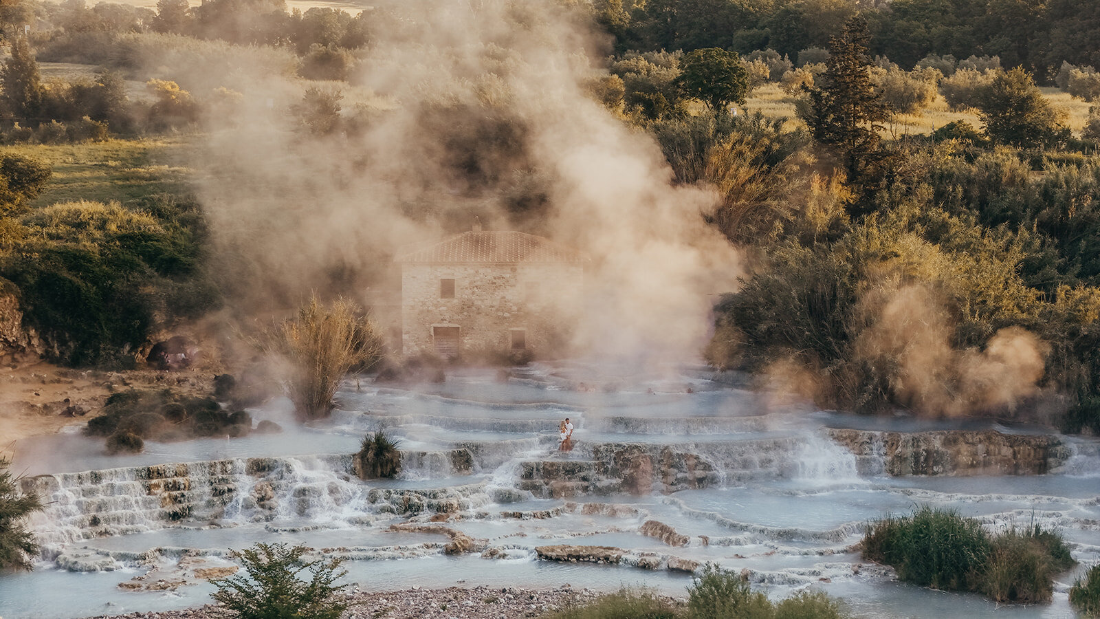couple pose at Saturnia hot springs