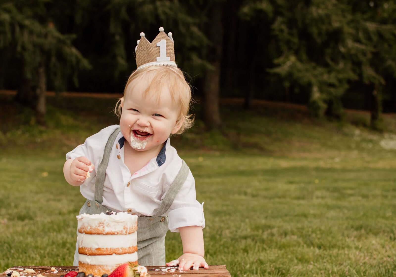 Little boy eating birthday cake.