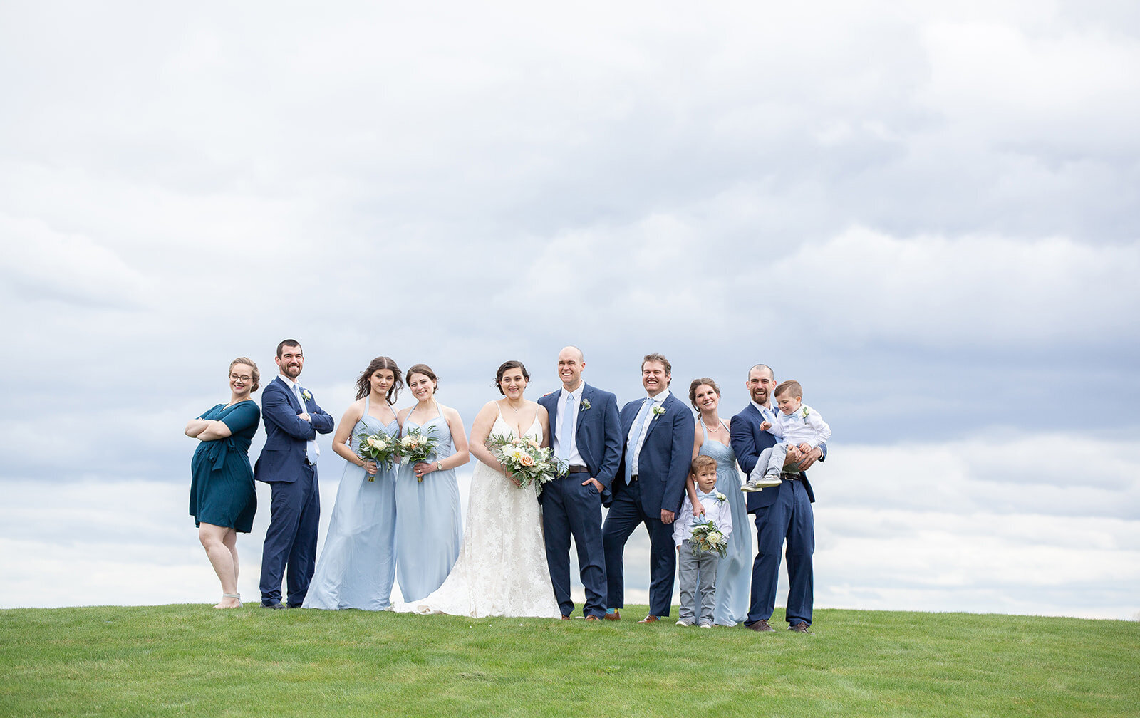 bridal party on hill for photo