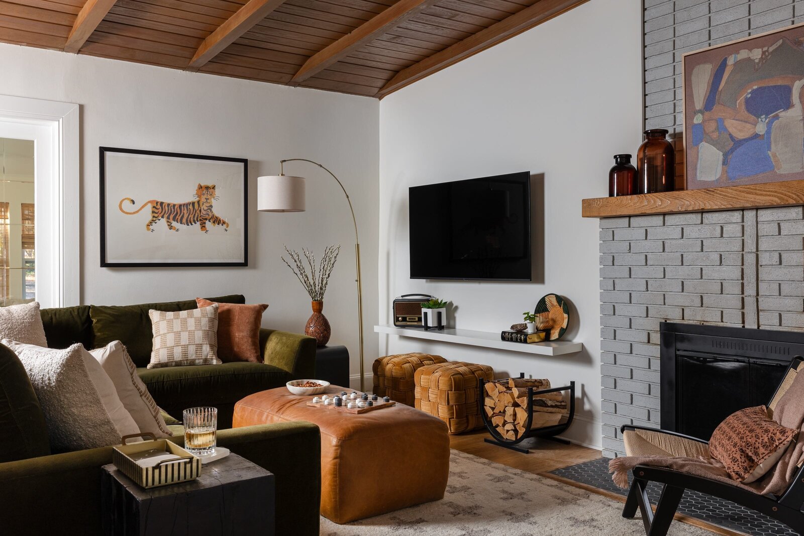 melinda chesson interiors murrayhill road modern living room green sectional leather ottoman brick fireplace