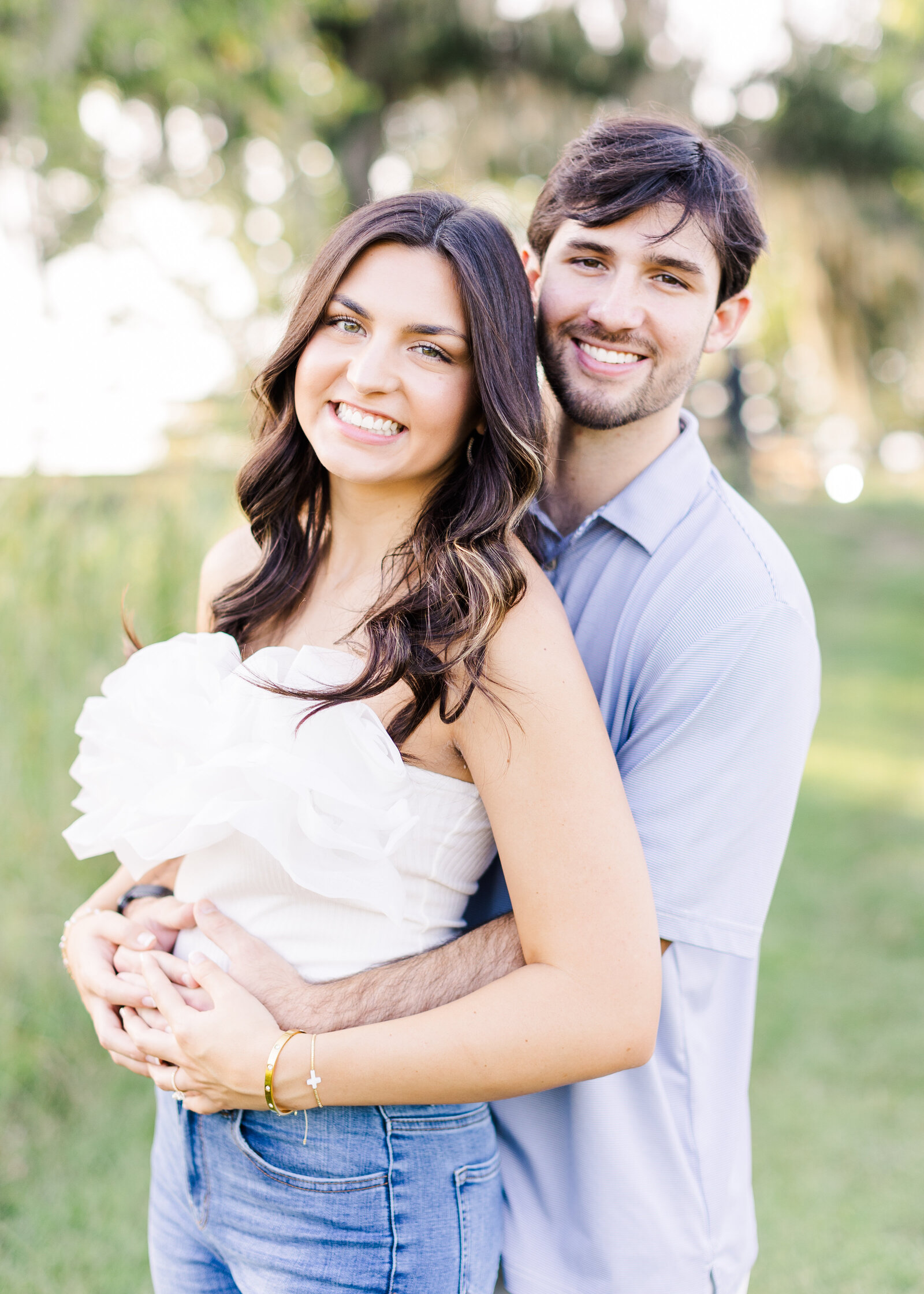 Lauren and Zac smiling together during their engagement session in Alabama, captured by a fine art photographer.