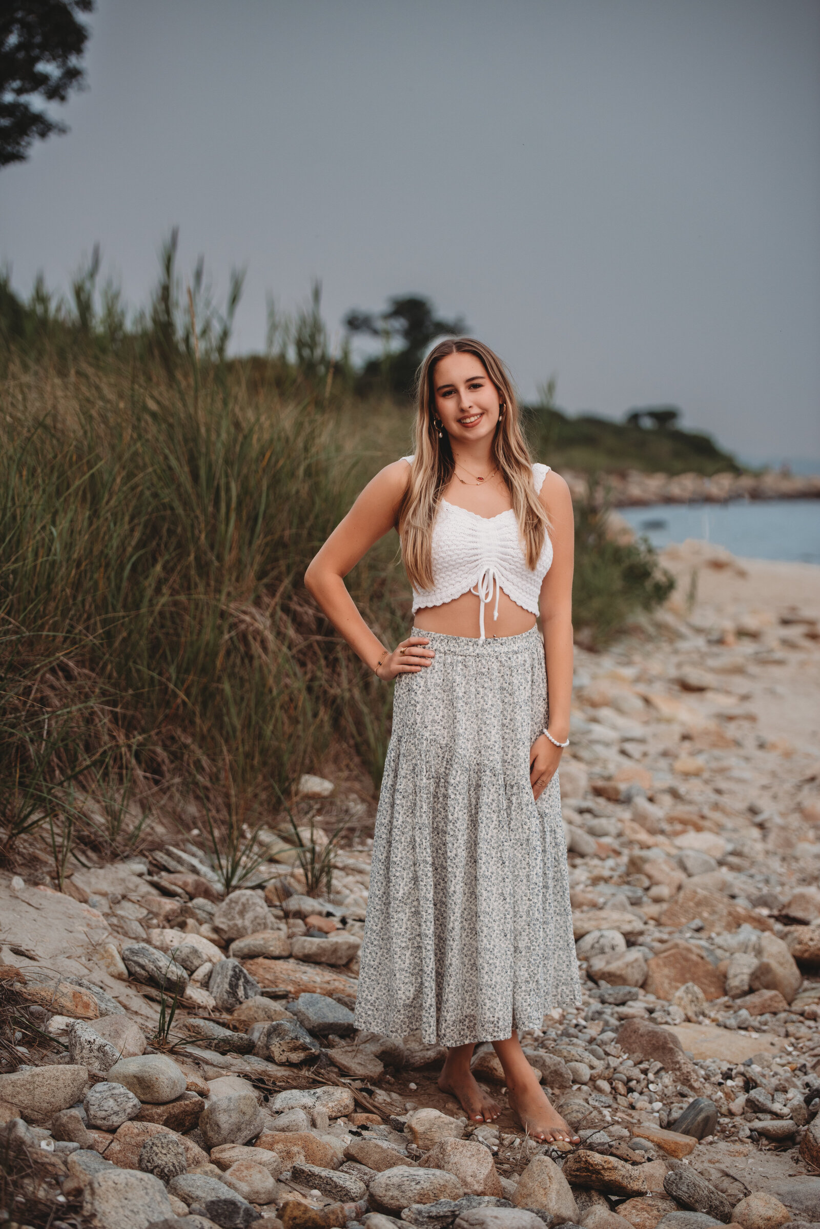 Celebrate your senior year with a stunning beachside photoshoot in Connecticut. This natural and relaxed high school senior session captures a timeless, coastal aesthetic perfect for showcasing your personality.
