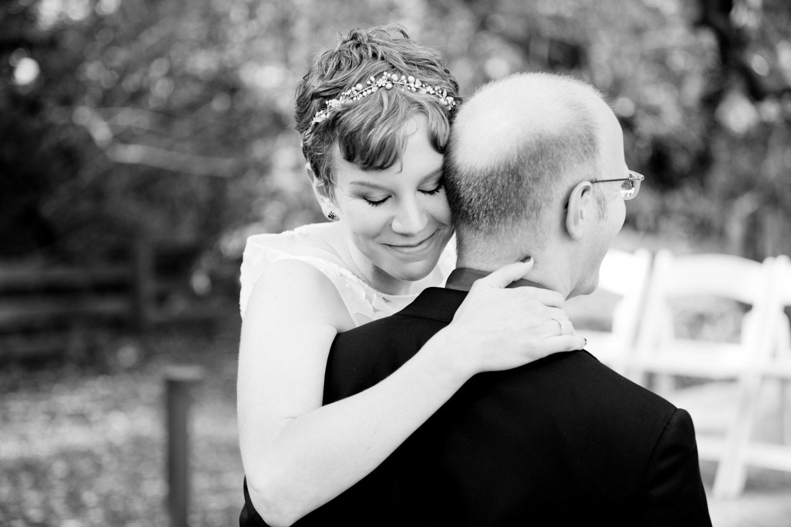 Bride and groom hug in romantic black and white portrait