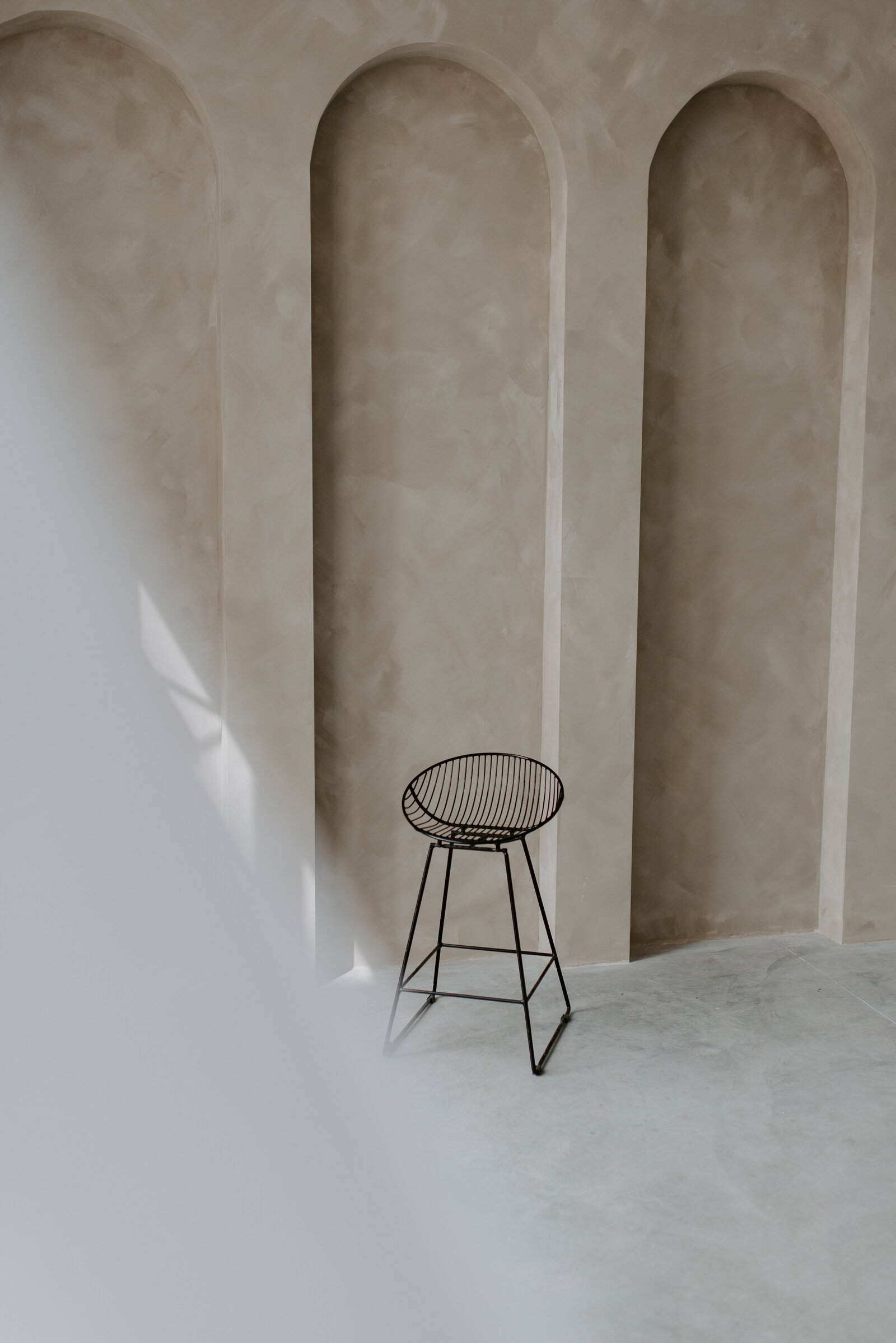 Black Stool Against Limewash Wall ABQ Photo Studio