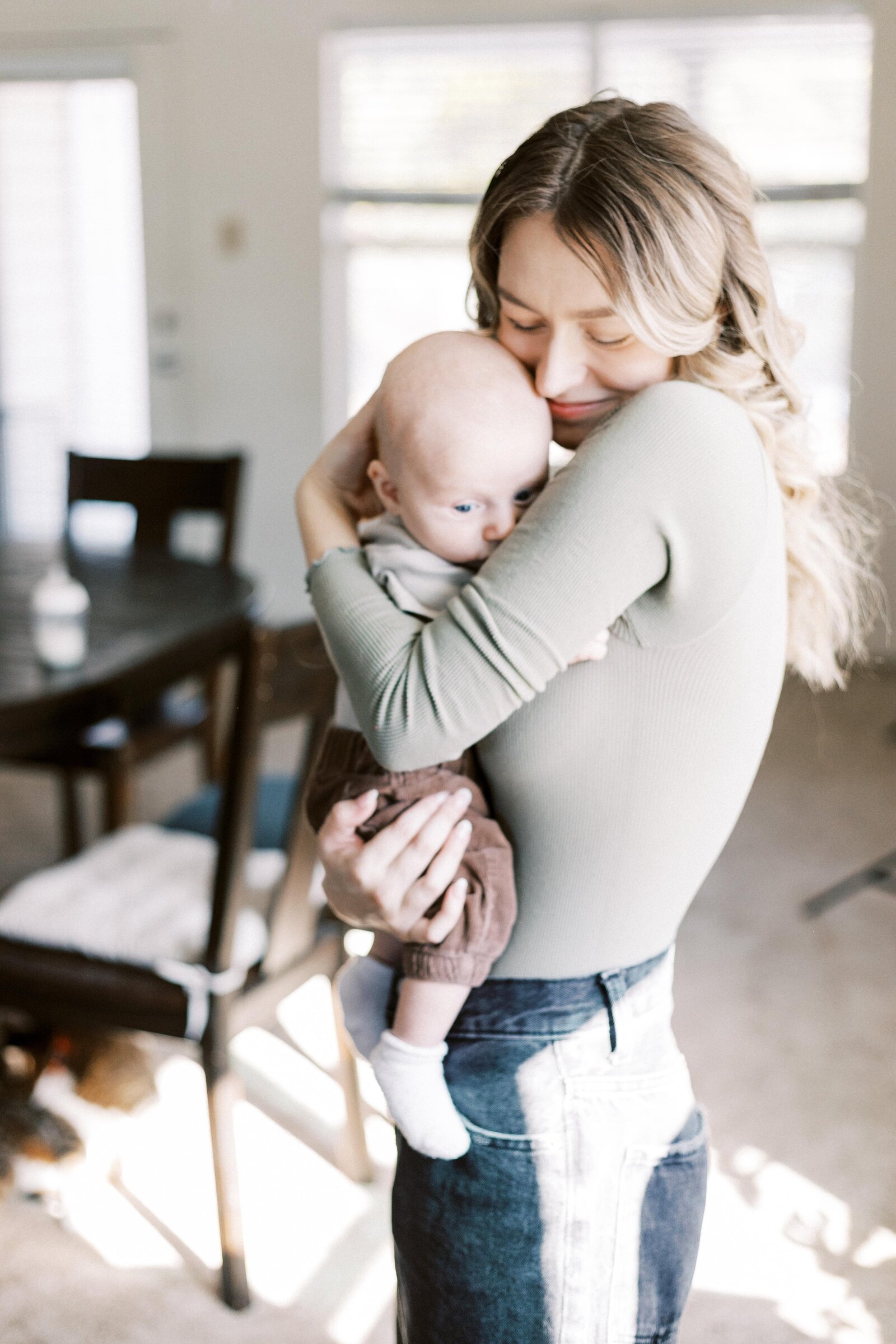 mom hugging baby in home during peoria illinois family photos 