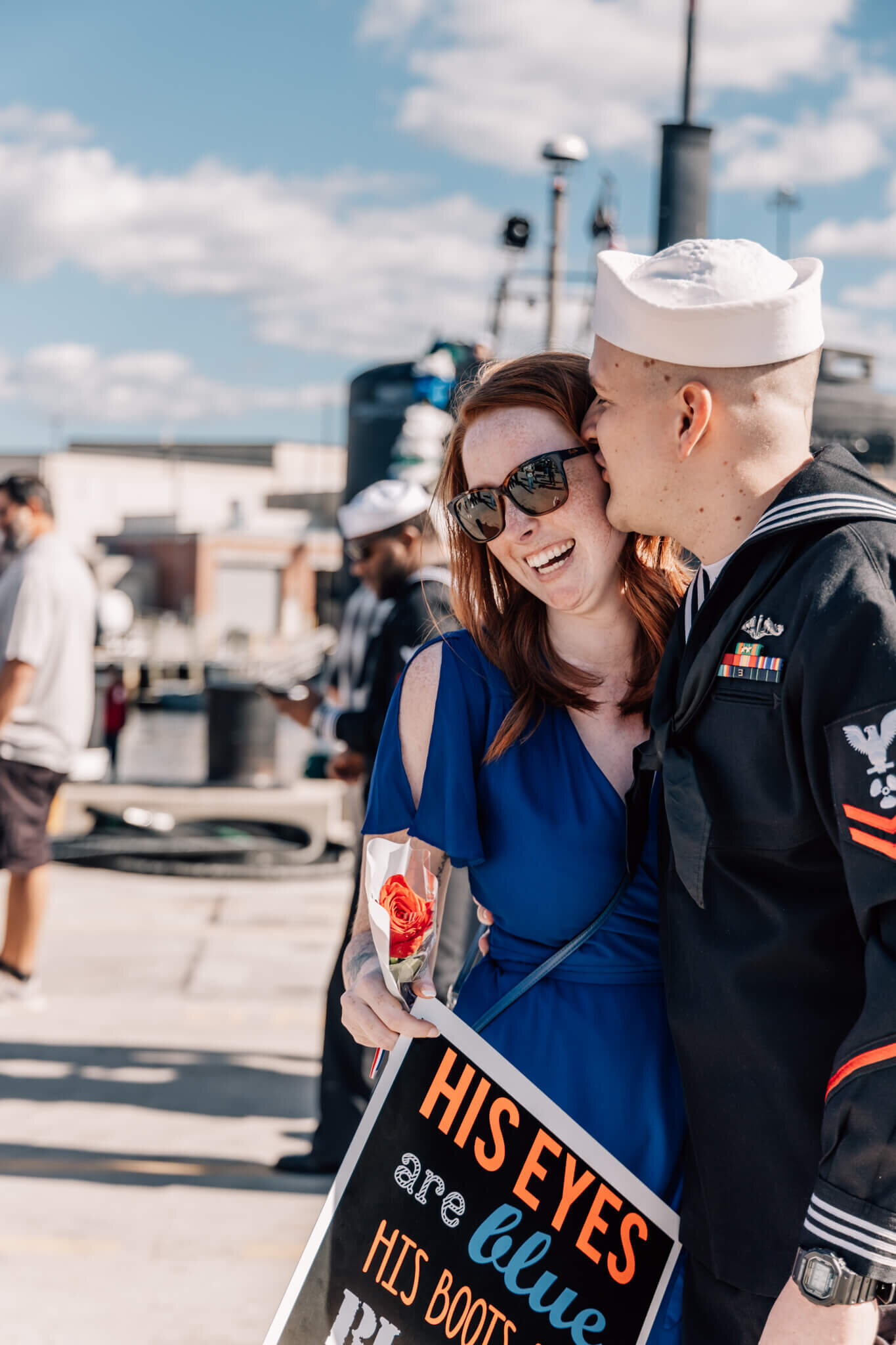 Petty officer second class kisses new fiance after proposing on the pier after returning from a deployment aboard the USS Montpelier.