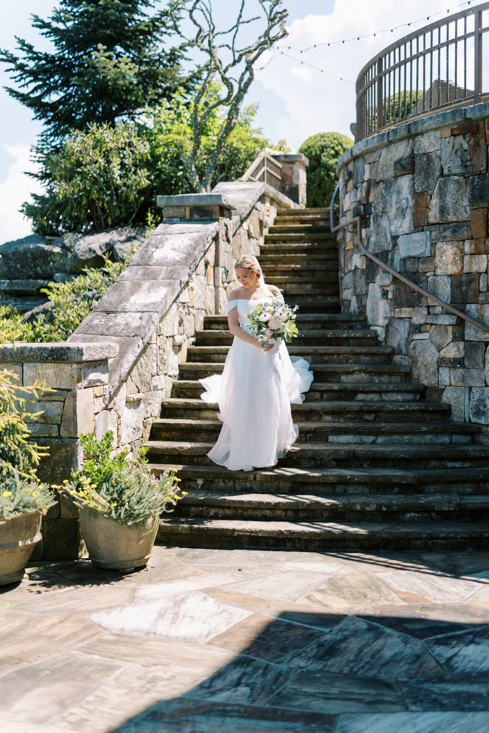 Bride walking down stone steps in Highlands, North Carolina