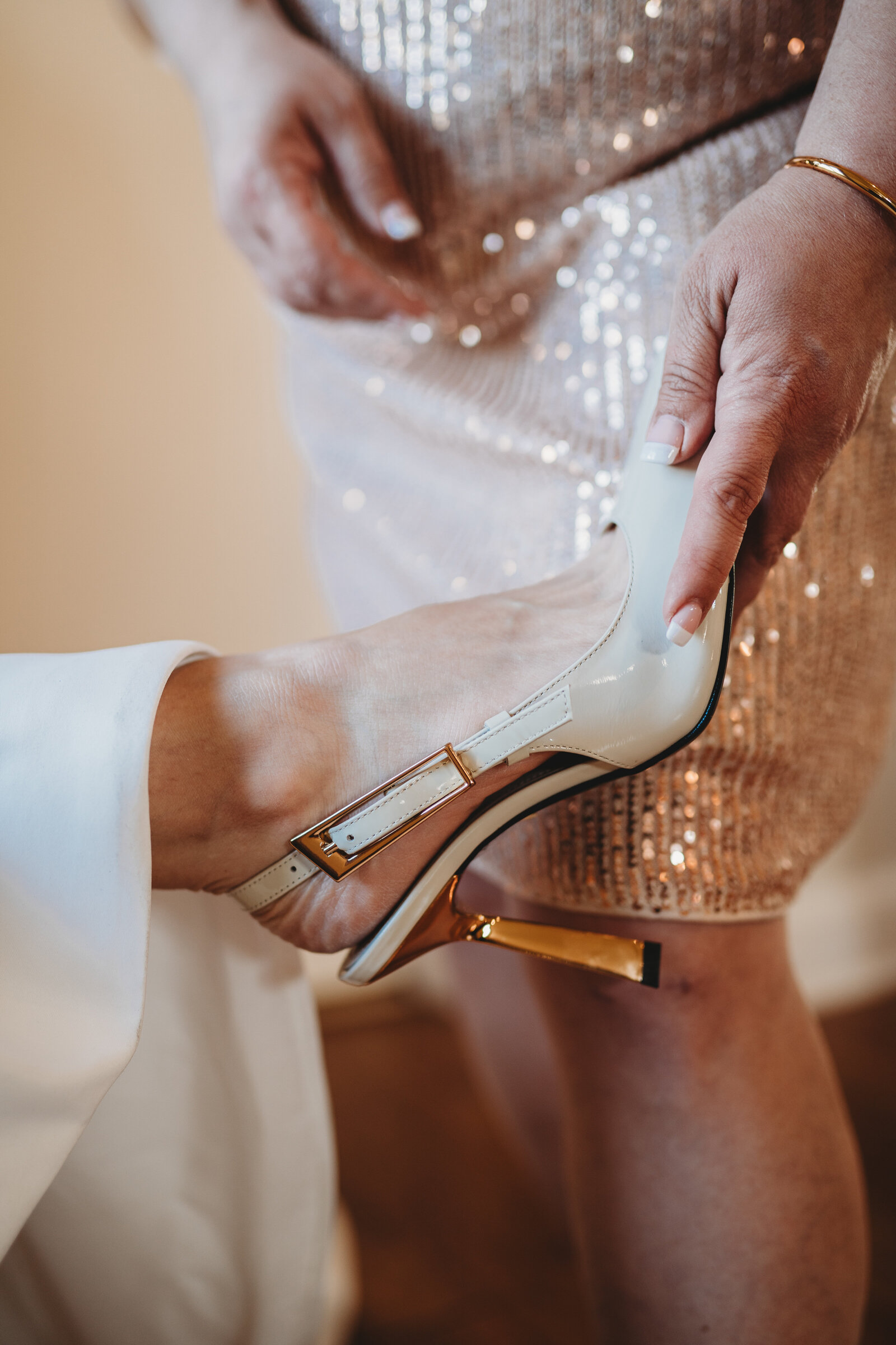 A stunning close-up of the bride's elegant wedding shoes, capturing a cherished getting-ready moment. This wedding detail photography highlights sophistication, style, and the intimate moments that make a wedding day truly special.